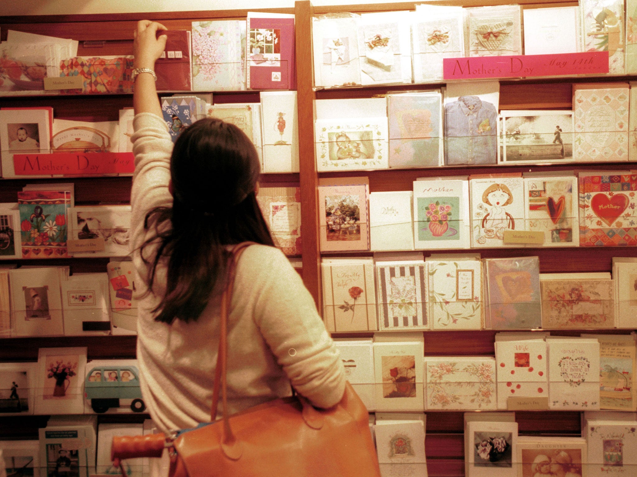 Cards buyer looks over Mother's day cards May 10, 2000 in the Papyrus card store in New York's Grand Central Station.