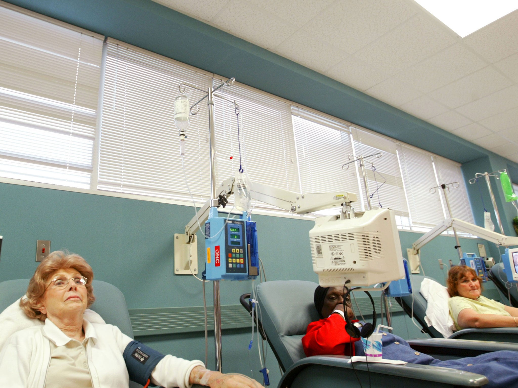 Cancer patients receive chemotherapy treatment at Cape Fear Valley Medical Center June 17, 2003 in Fayetteville, North Carolina. The chairs in the chemotherapy center are set up side-by-side, allowing patients to interact.