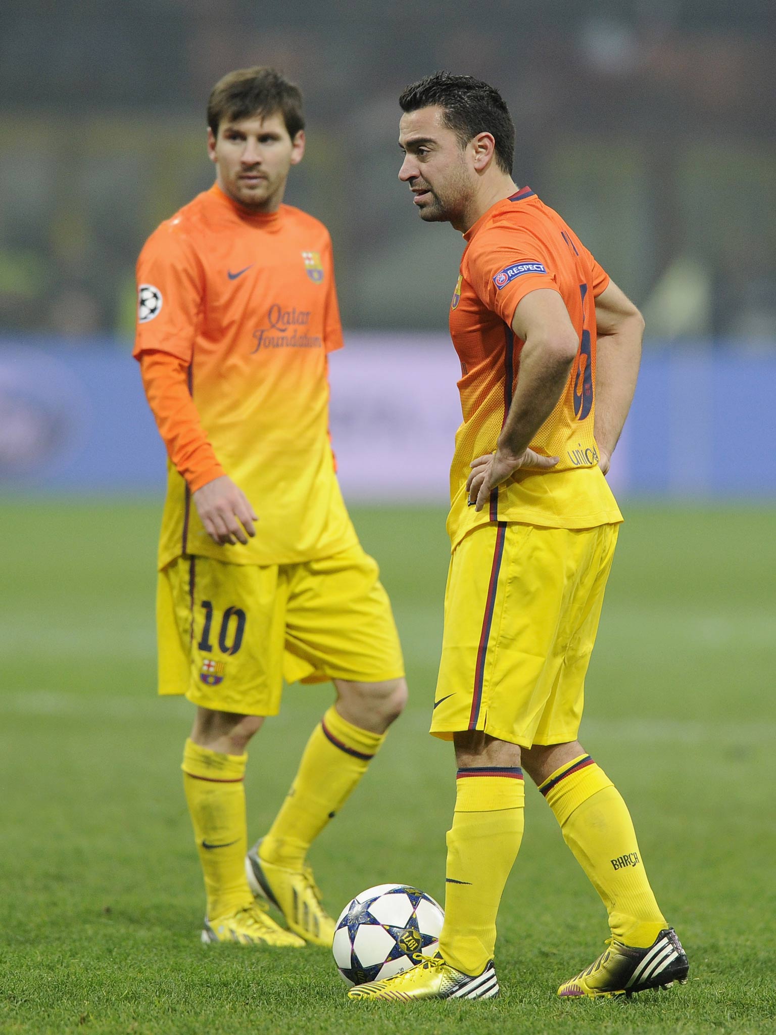 Barcelona duo Xavi and Lionel Messi pictured in the first leg against AC Milan