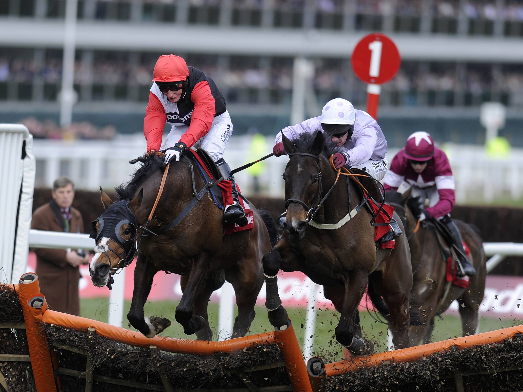 Paul Carberry riding Solwhit (C) clear the last to win The Ladbrokes World Hurdle Race from Celestial Halo