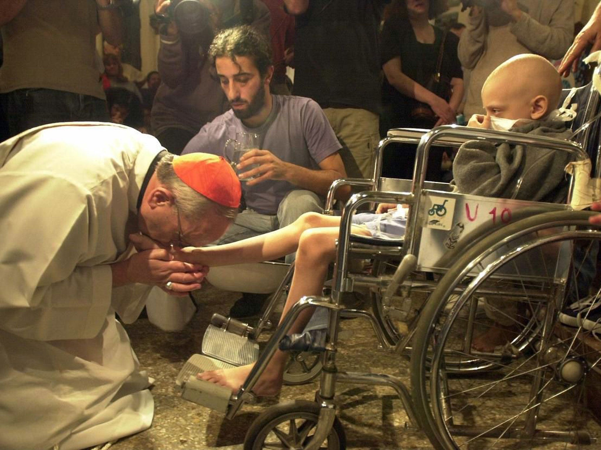 Jorge Bergoglio washes the feet of believers at a Children’s Hospital during Easter Mass in Buenos Aires