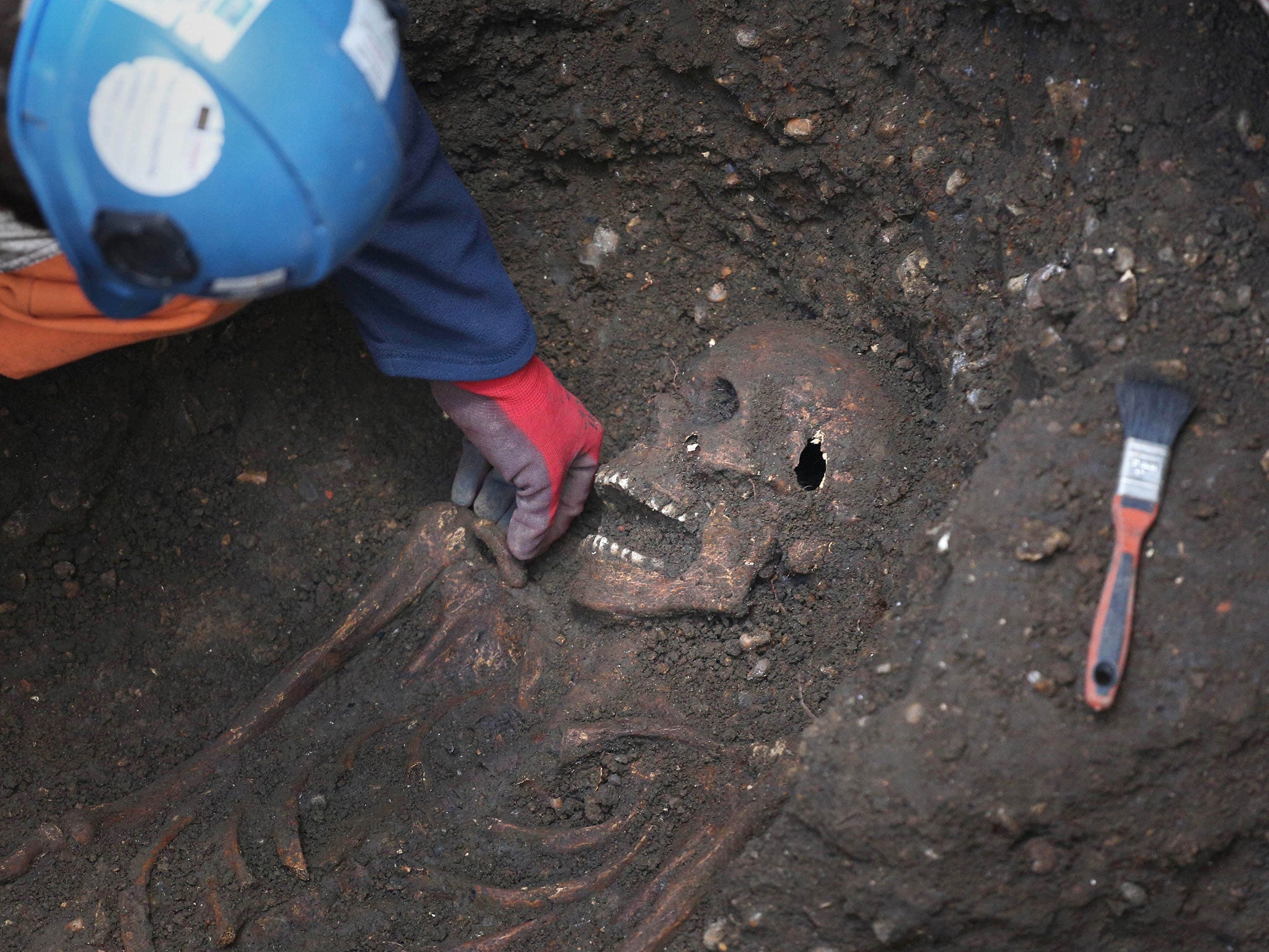 Archaeologist and site supervisor Sam Pfizenmaier from the Museum of London's Archaeology department works in a grout shaft after a 14th century burial ground was discovered in Farringdon, London