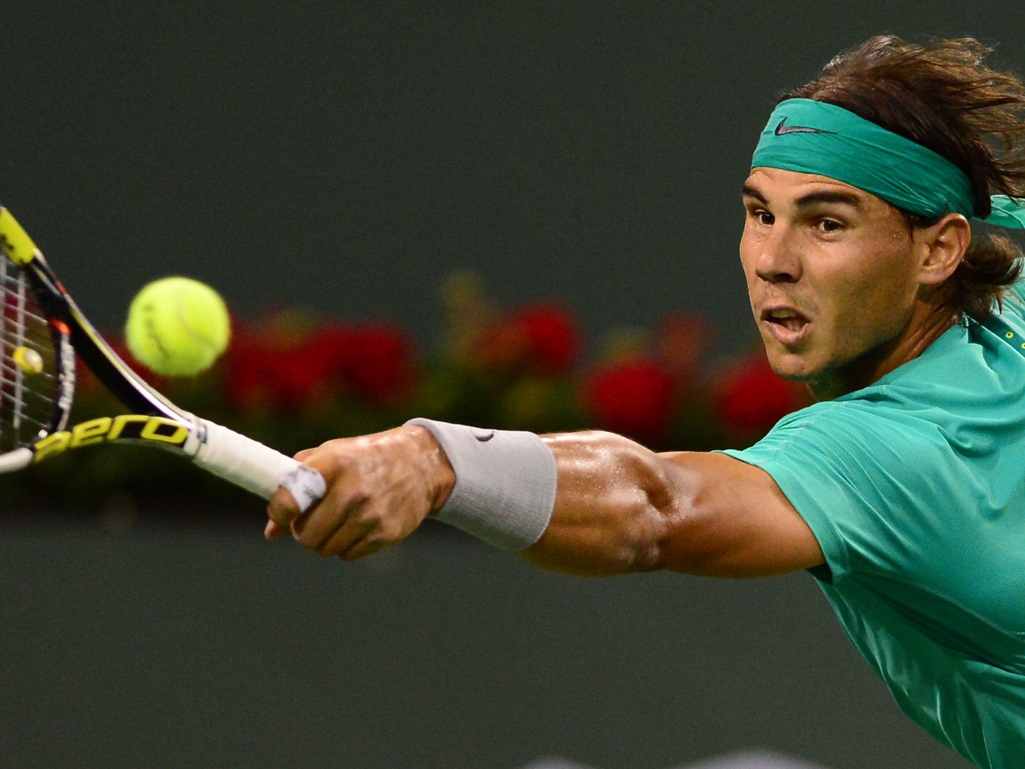 Rafael Nadal of Spain hits a backhand return against Roger Federer