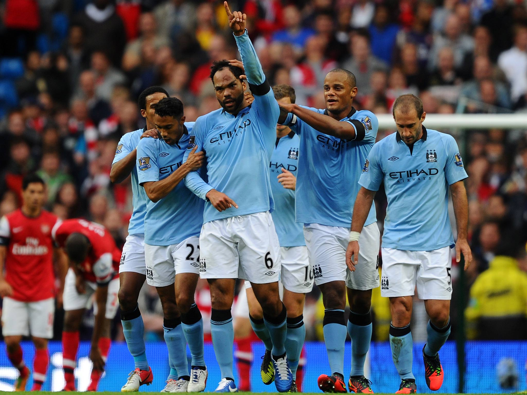 Joleon Lescott celebrates a goal against Arsenal