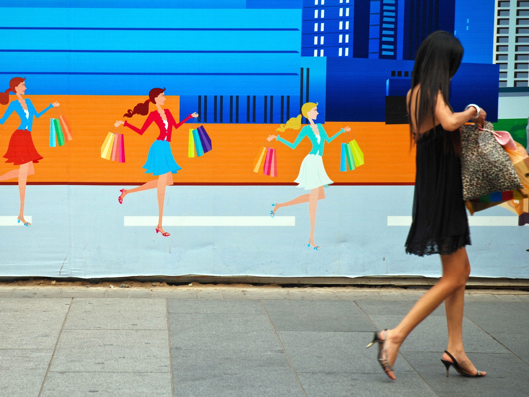 A Chinese woman leaves a shopping mall in Beijing on September 22, 2009. Women have become a major driving force behind China's economic growth.