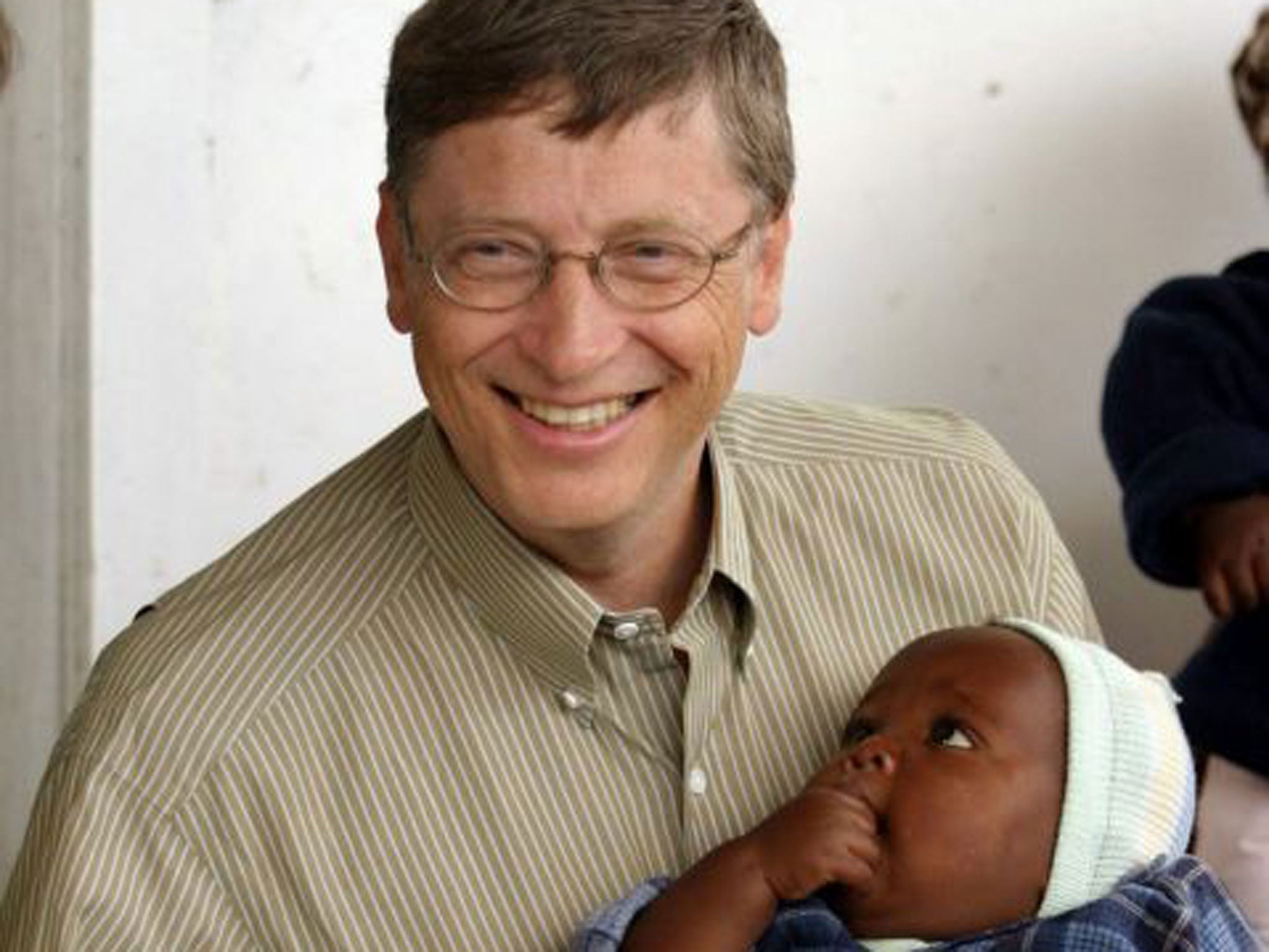 Bill Gates, co-founder of the Bill and Melinda Gates Foundation, with a young patient on a malaria vaccine trial in Mozambique