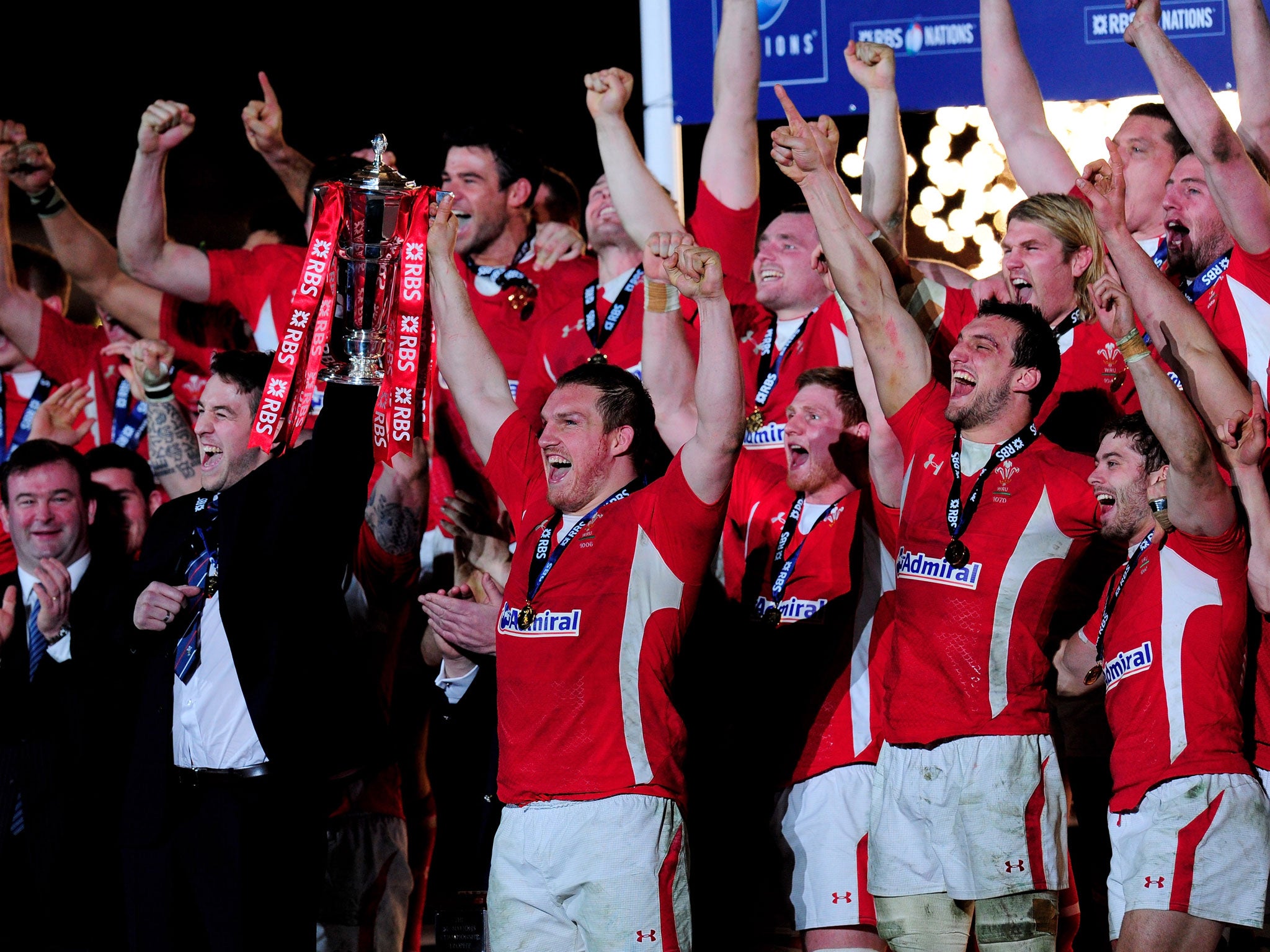 The injured Ryan Jones and Gethin Jenkins of Wales lift the Six Nations Championship trophy