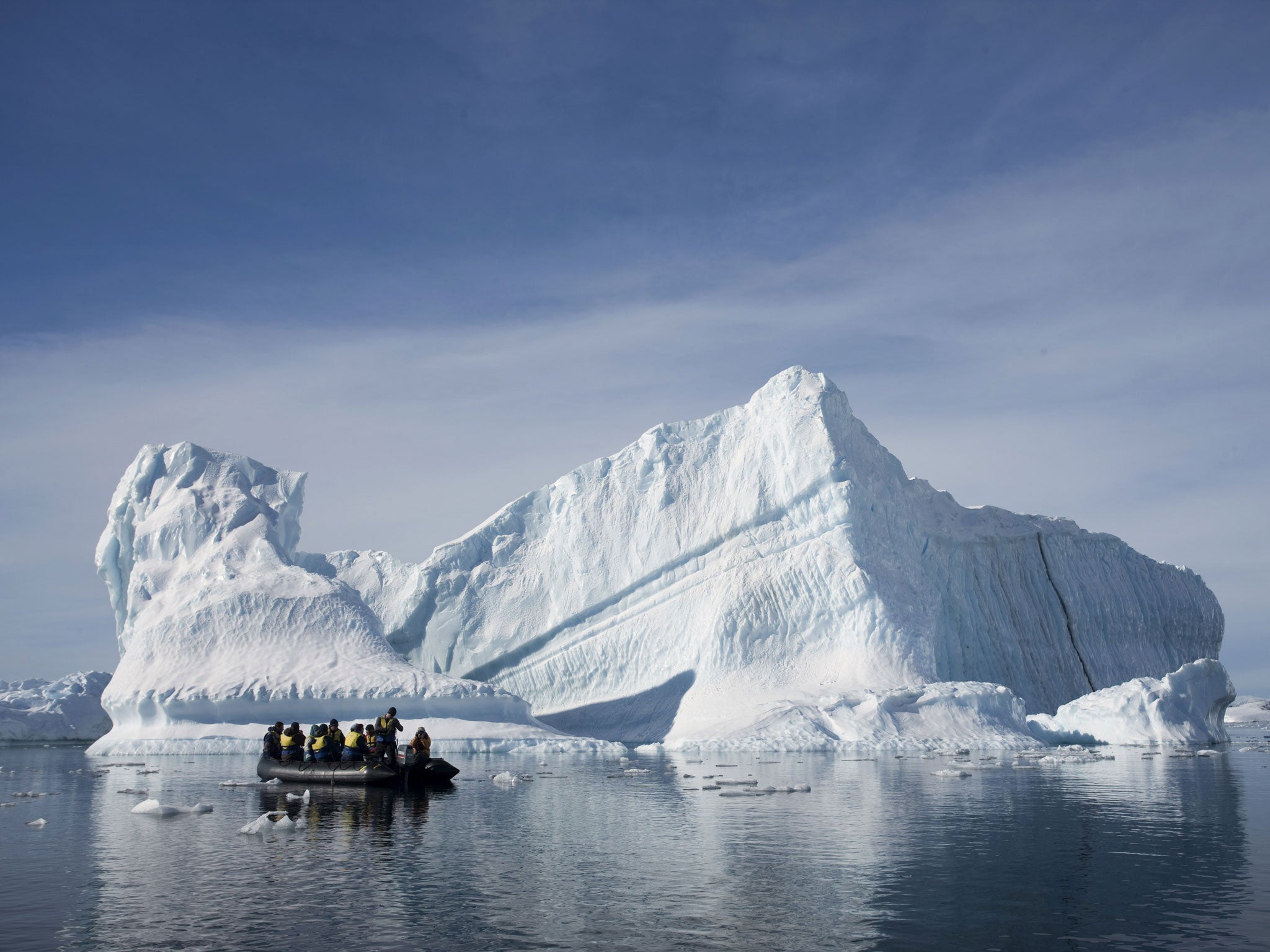 White stuffed: Tourists aboard an inflatable take photographs close up to an Antarctic iceberg