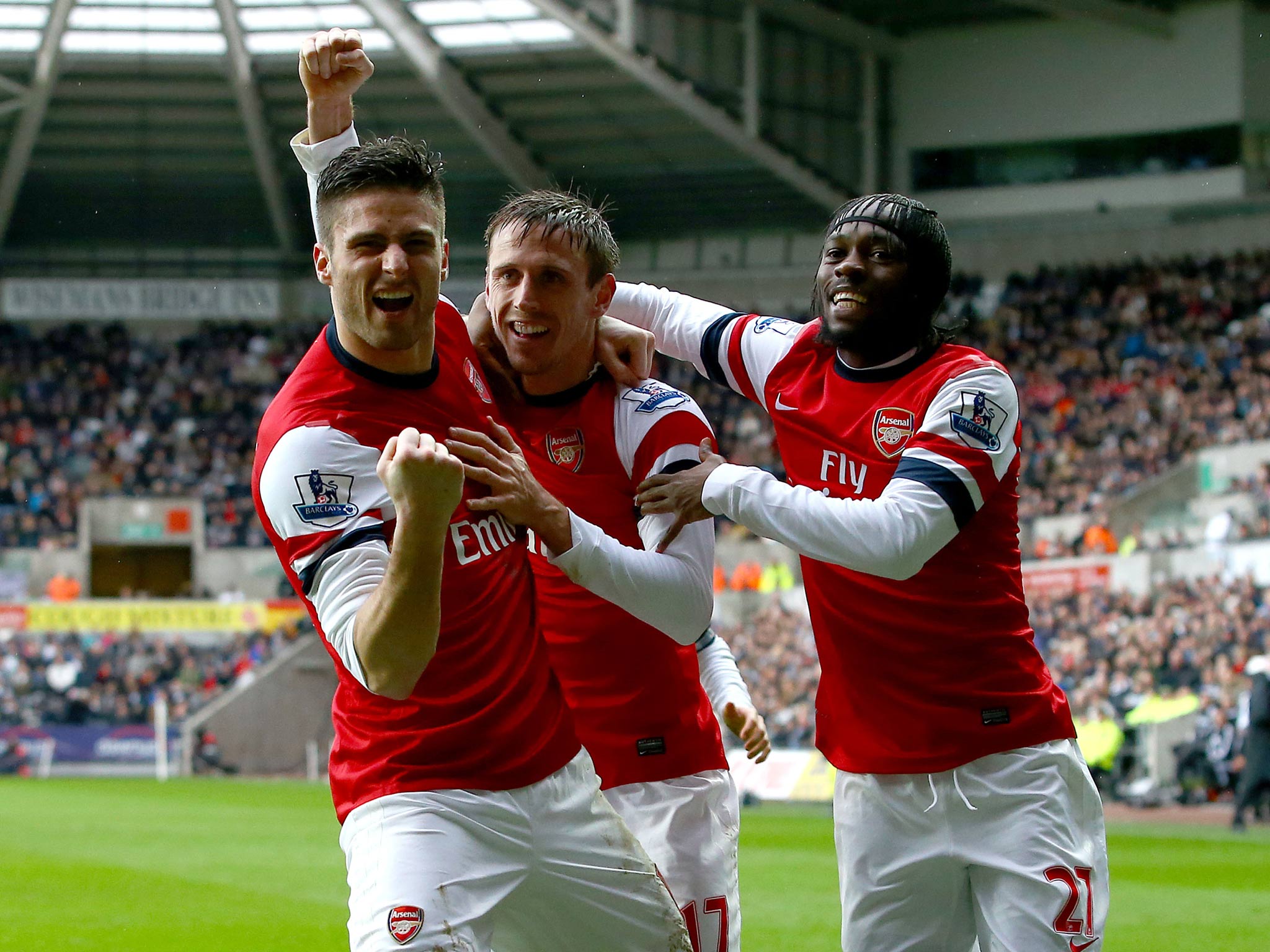 Nacho Monreal of Arsenal (C) celebrates his goal against Swansea with team mates Olivier Giroud(L) and Gervinho