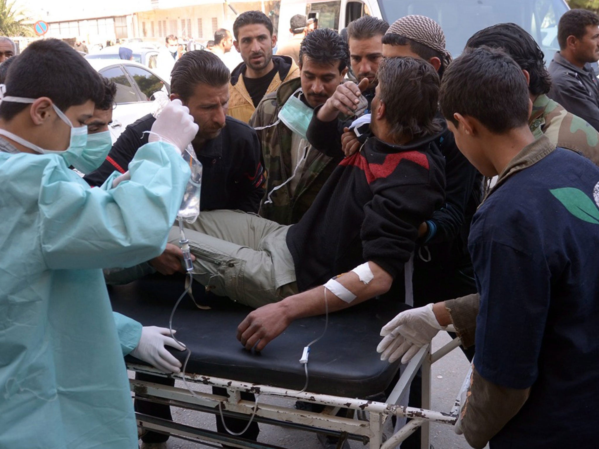 A wounded man is taken for first aid at hospital after what the government claimed to be a chemical weapons attack by rebels in Aleppo