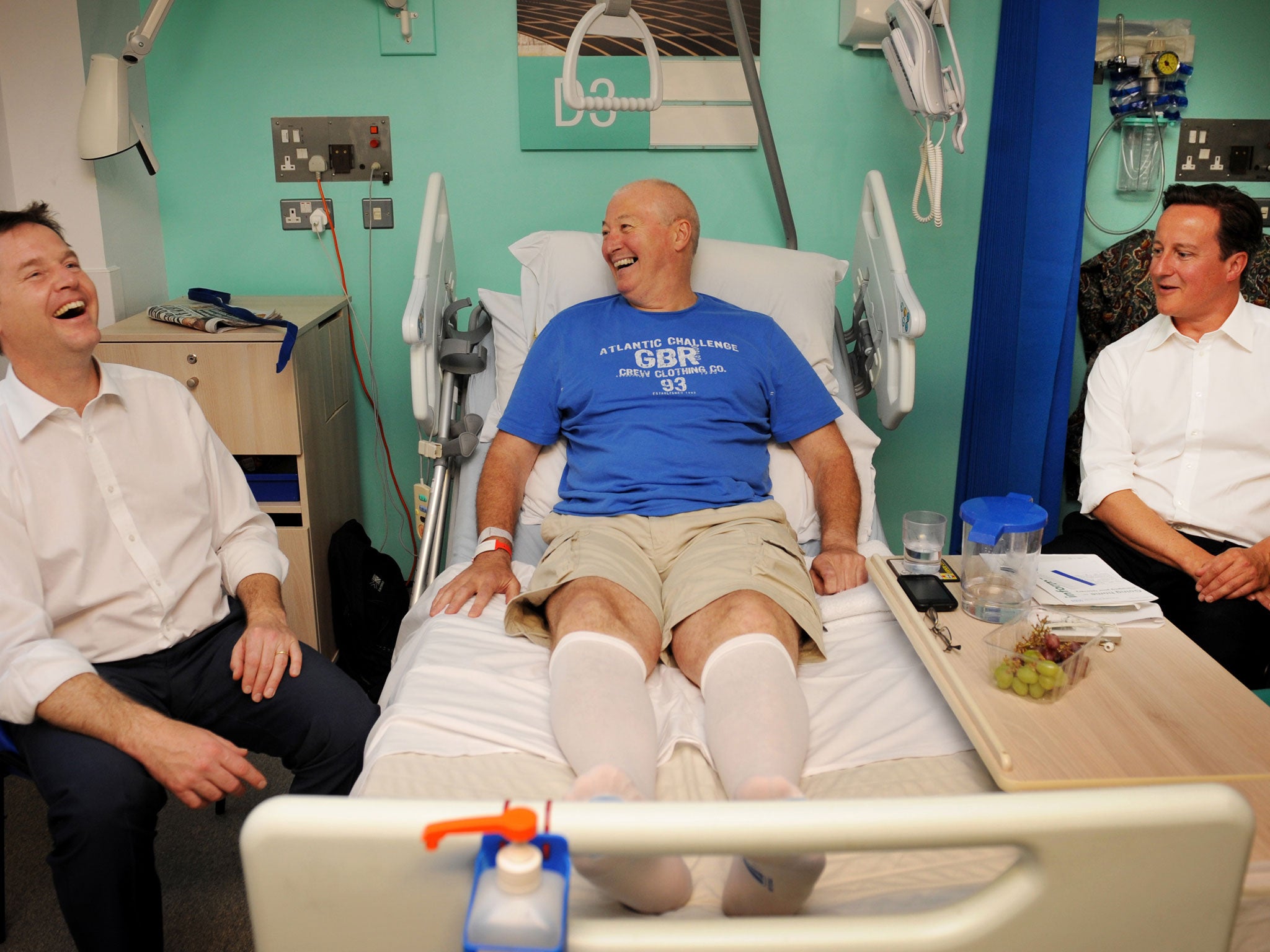 British Deputy Prime Minister Nick Clegg (L) and British Prime Minister David Cameron (R) meet hip operation patient Andrew Sarton after unveiling major changes to planned NHS (National Health Service) reforms at Guys Hospital in London, on June 14, 2011.