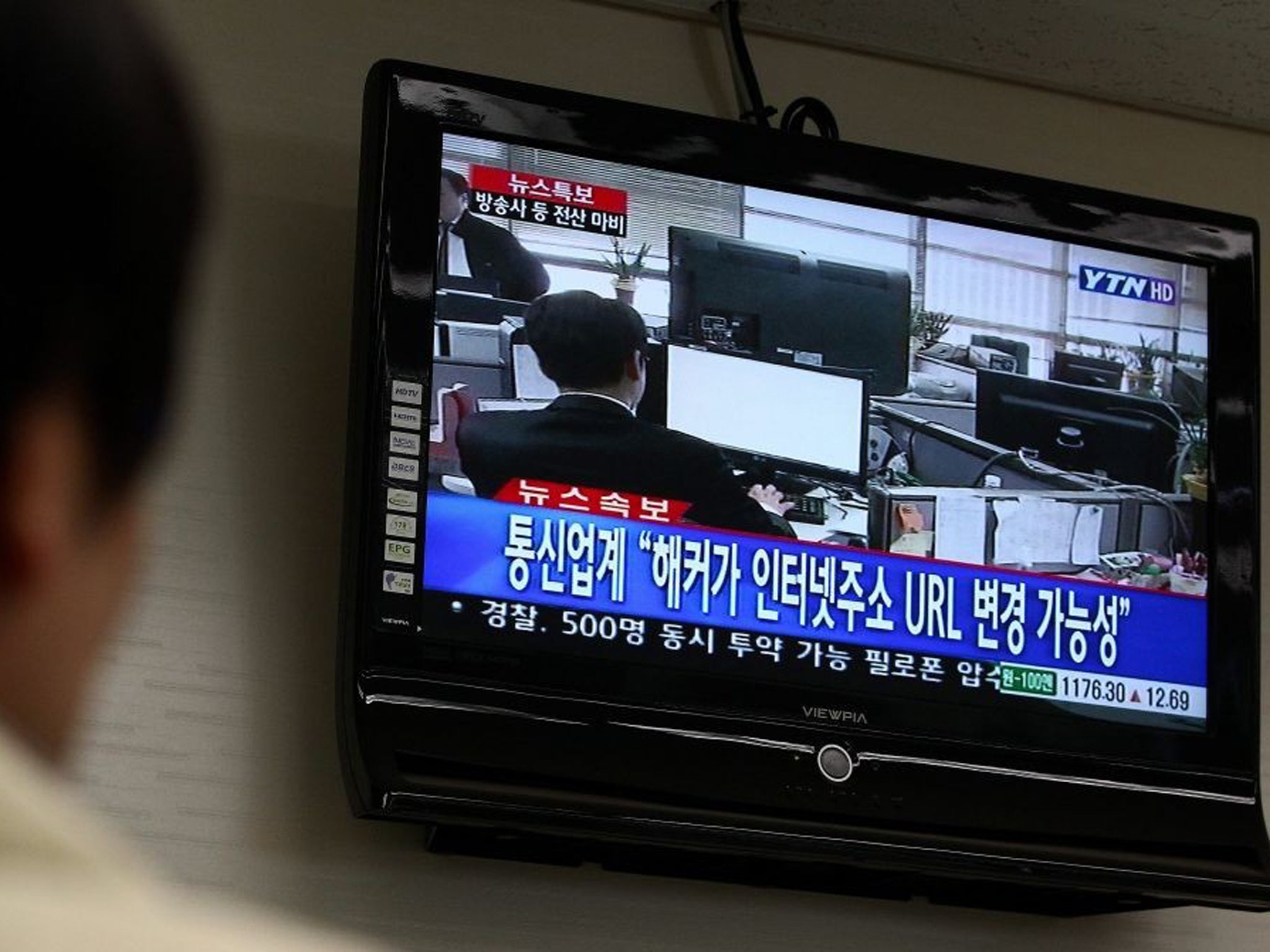 A man watches breaking news on computer failures, in Seoul, South Korea