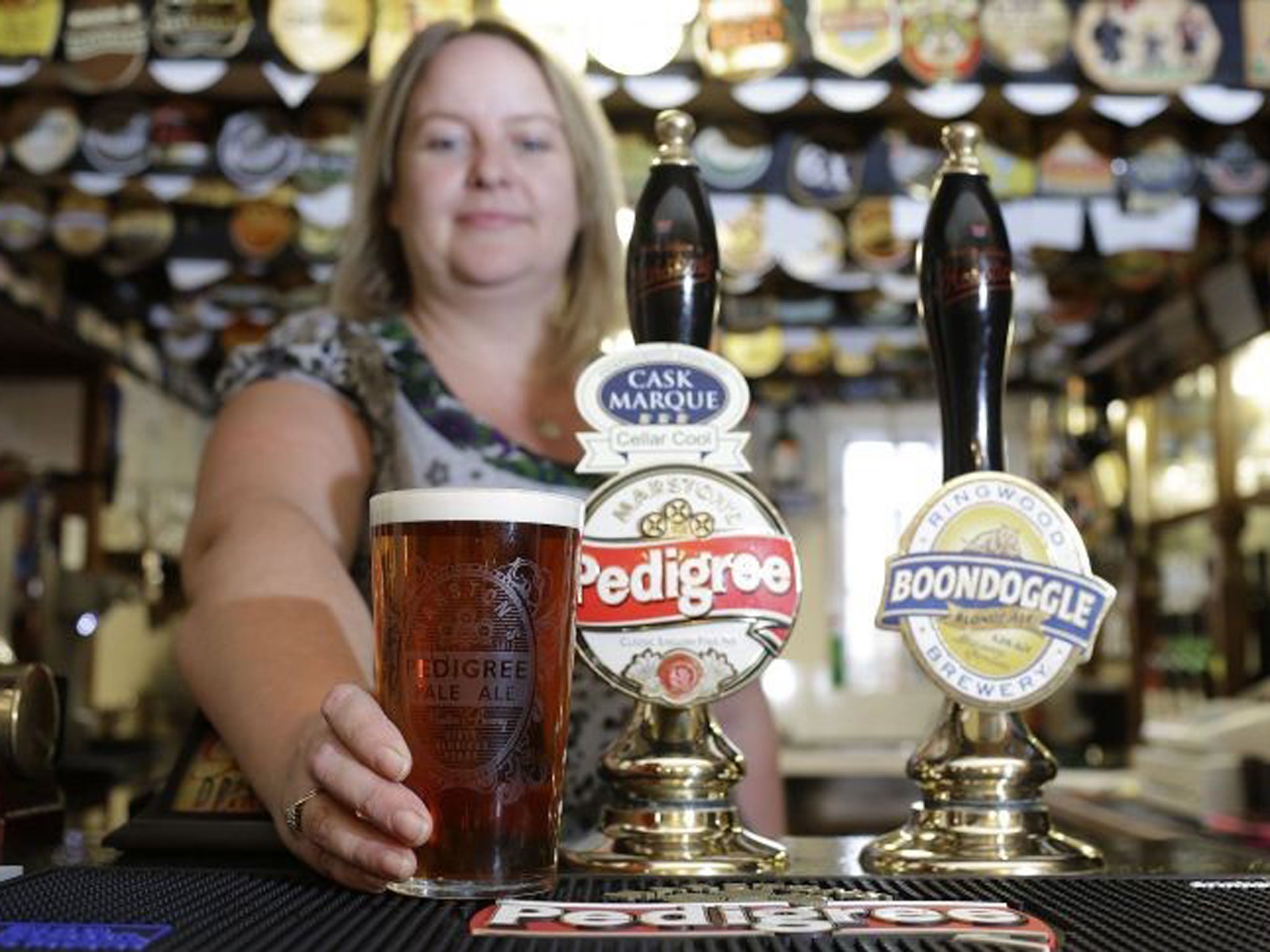 Landlady Katy Boulter pours a pint at The Royal Oak at Barton-under-Needwood near Burton