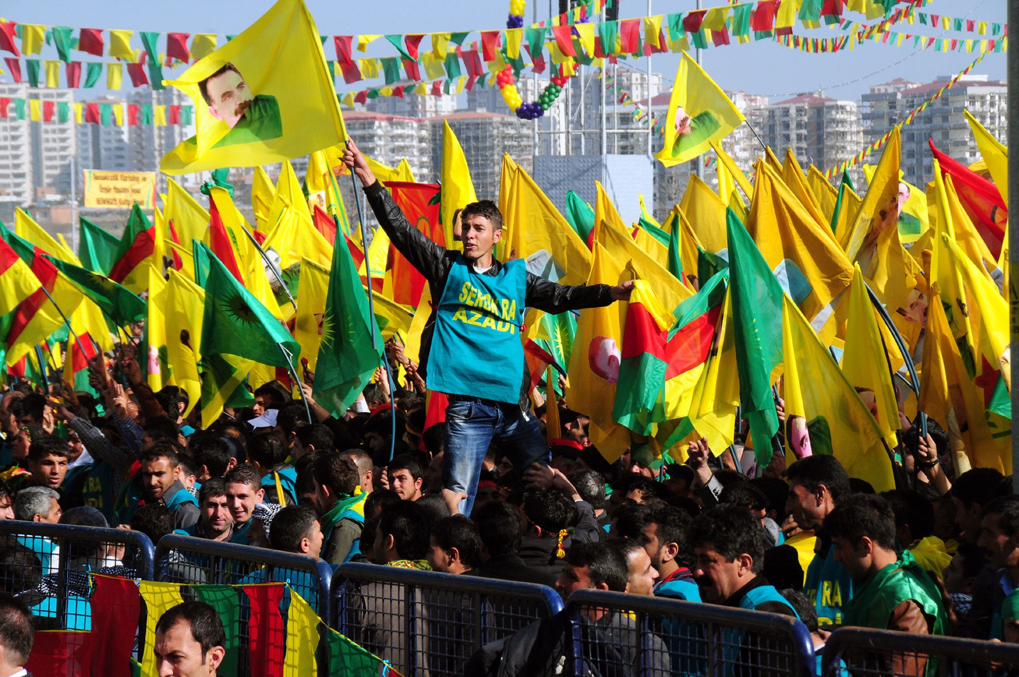 A Kurdish man waves a poster of founder of PKK (Kurdish Worker Party) Abdullah Ocalan during celebrations of Nowruz, the Persian New Year festival, on March 21, 2013 in Diyarbakir