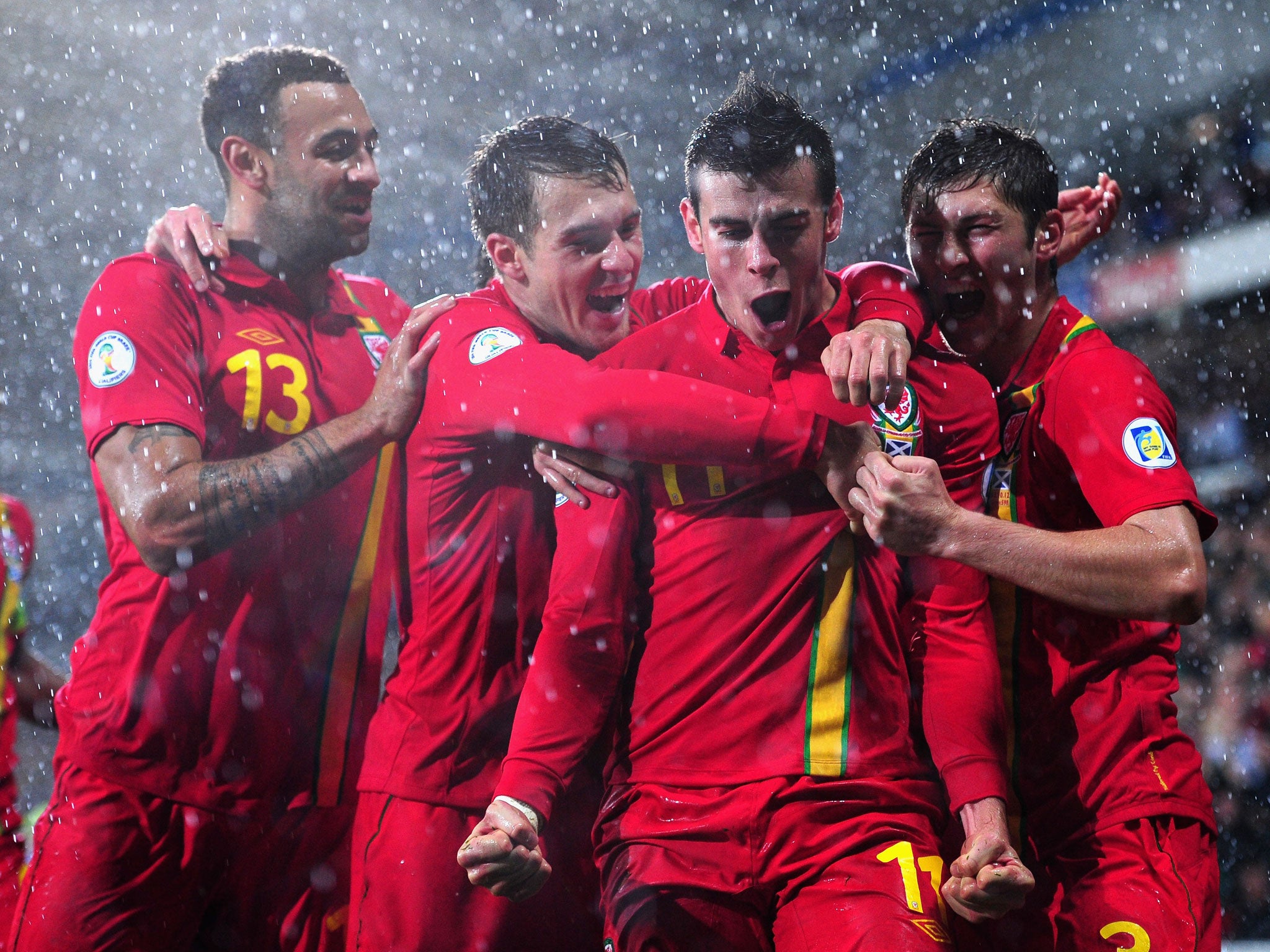 Gareth Bale is mobbed after his winning goal against Scotland in October