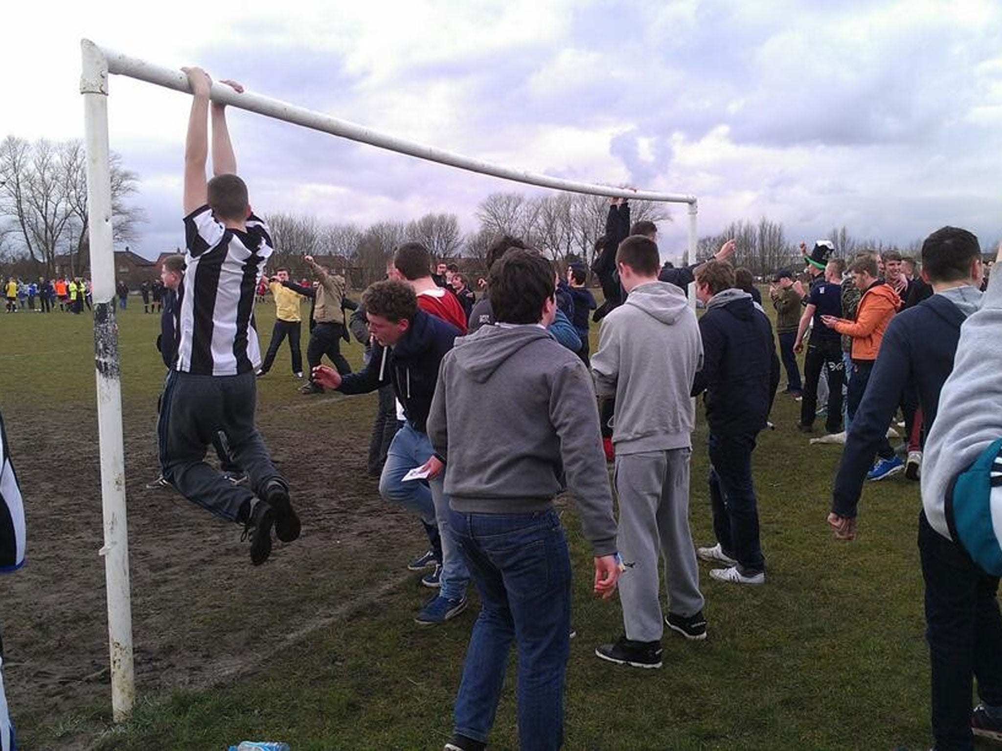 Pictures of Geordie fans hanging on posts and walking on the pitches from the Cosmos club website.