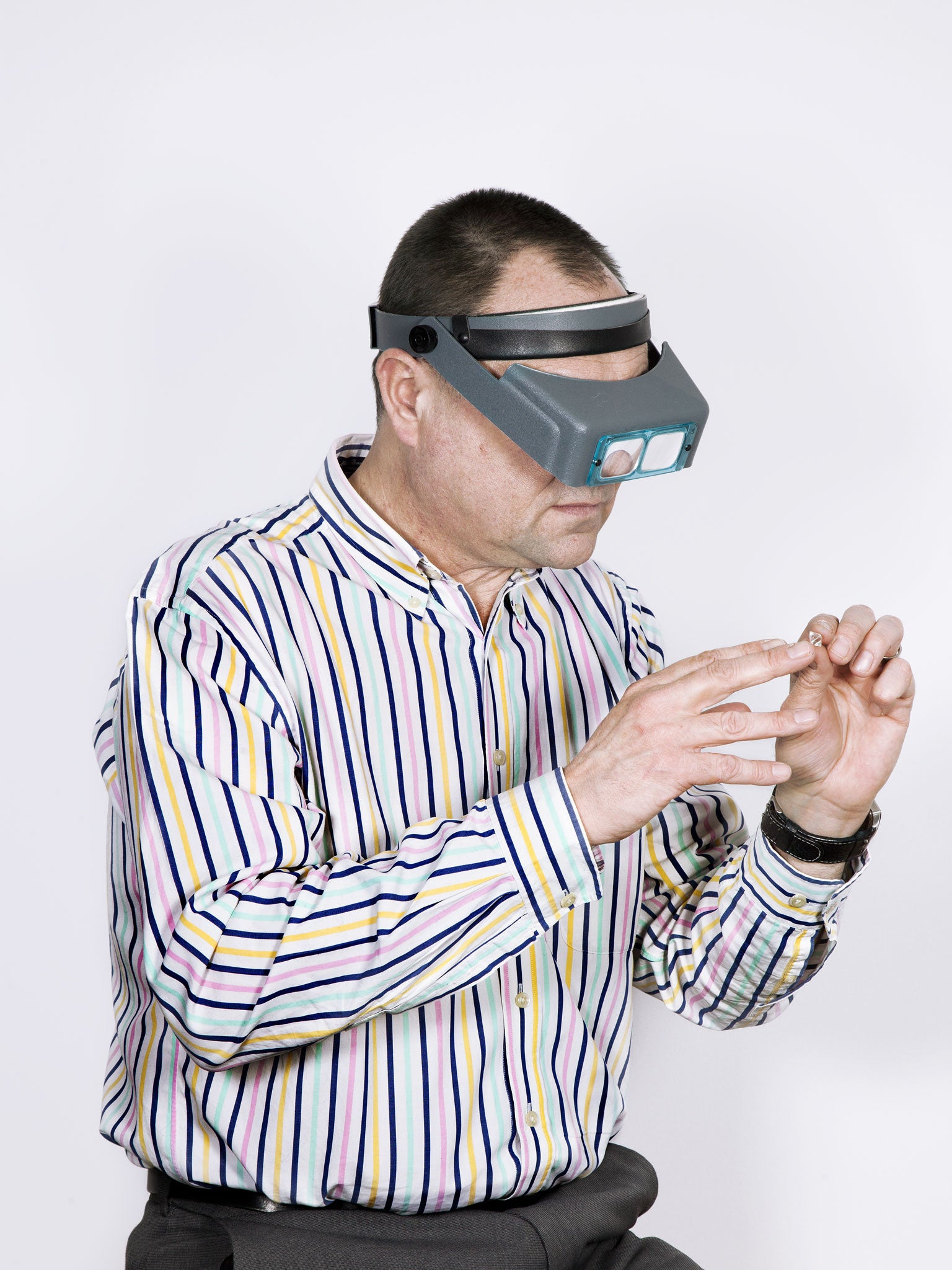 An employee at De Beers’ London headquarters considers the distinction of a diamond.