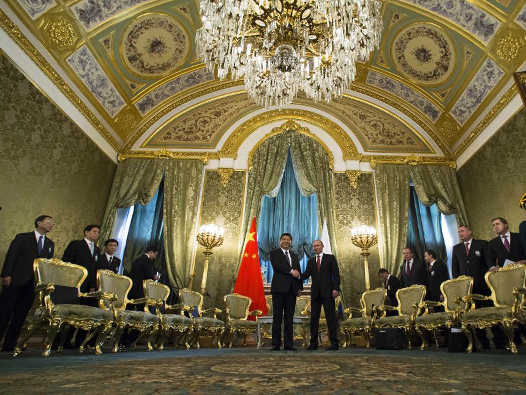 Vladimir Putin and Xi Jinping shake hands in the impressive St George Hall in the Kremlin yesterday