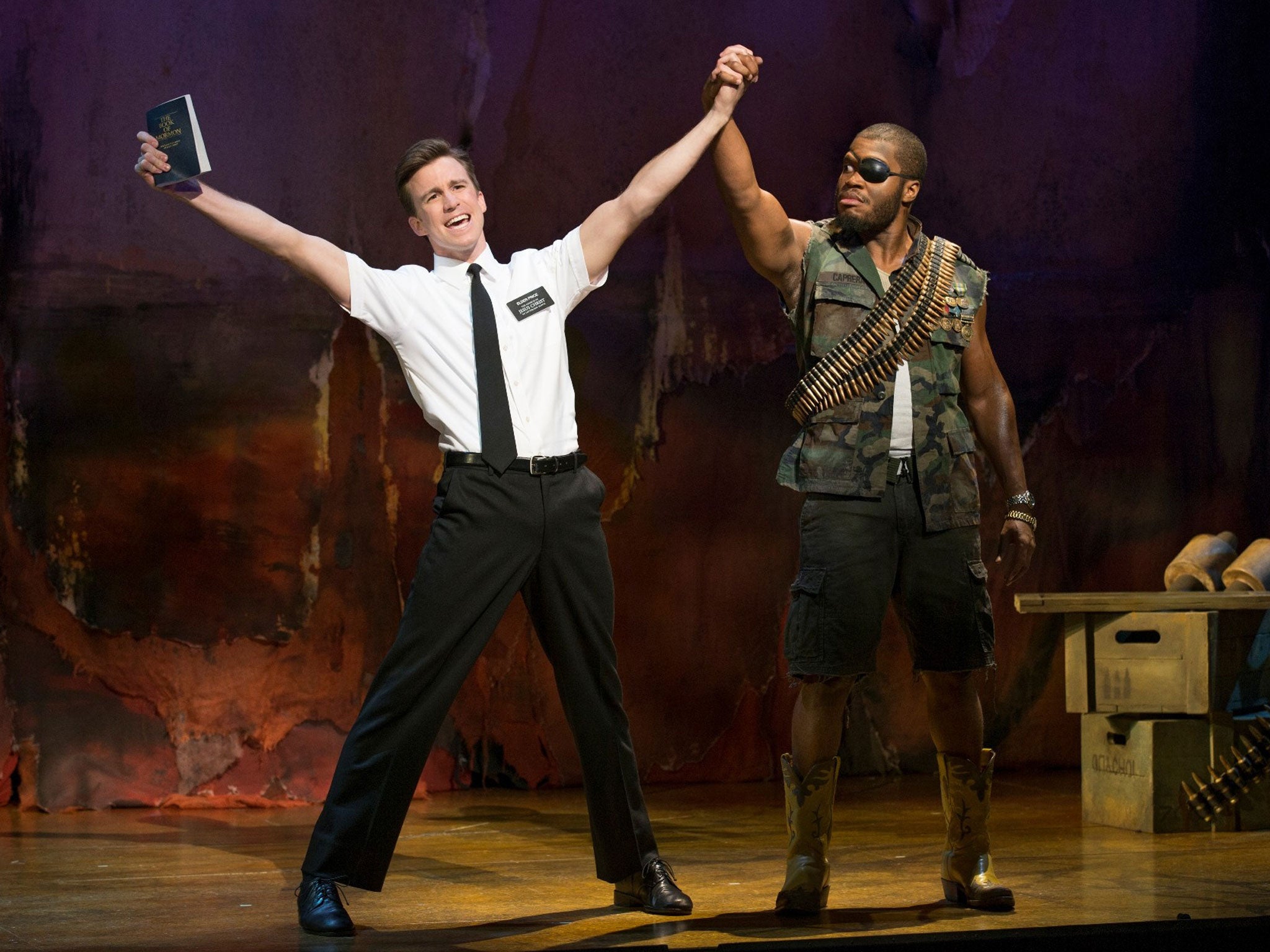 Happy clappy: The plastic grin on Gavin Creel’s Elder Price, left, makes him look like a living cartoon