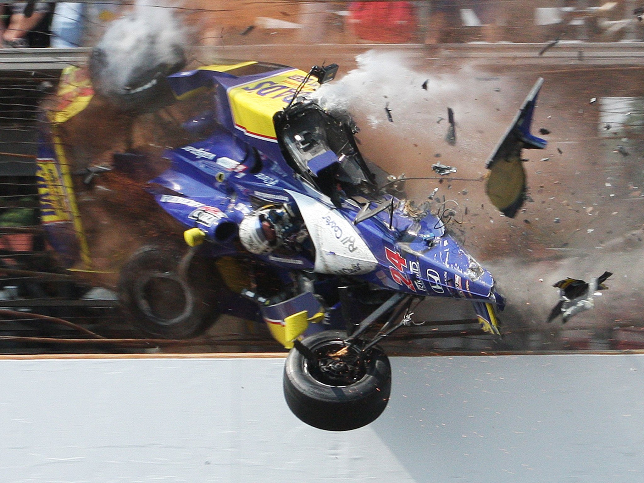 Flying finish: Mike Conway smashes into the fence on the last lap of the Indy 500 in 2010; he crashed again at the same place last year