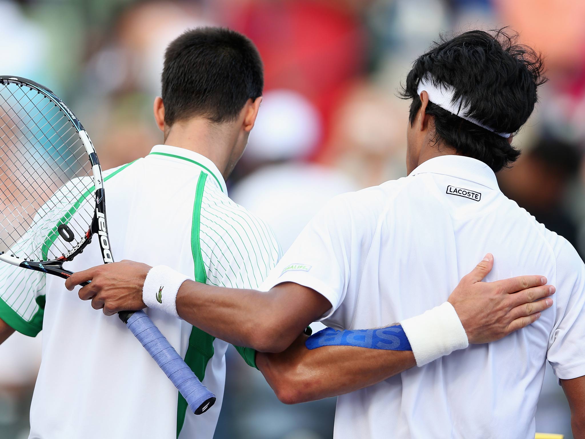 Novak Djokovic of Serbia walks off court after shaking hands at the net after his straight victory against Somdev Devvarma