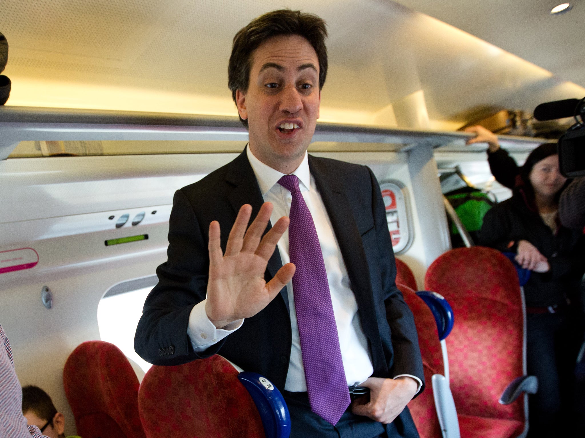 Ed Miliband talking to voters on a train to Carlisle