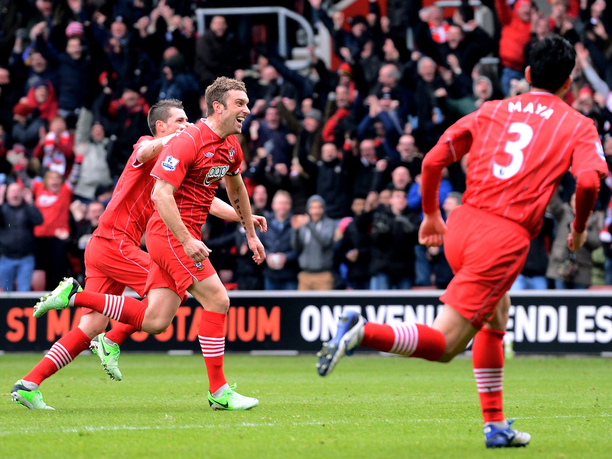 Rickie Lambert (2nd L) of Southampton celebrates with teammates after scoring his team's second goal