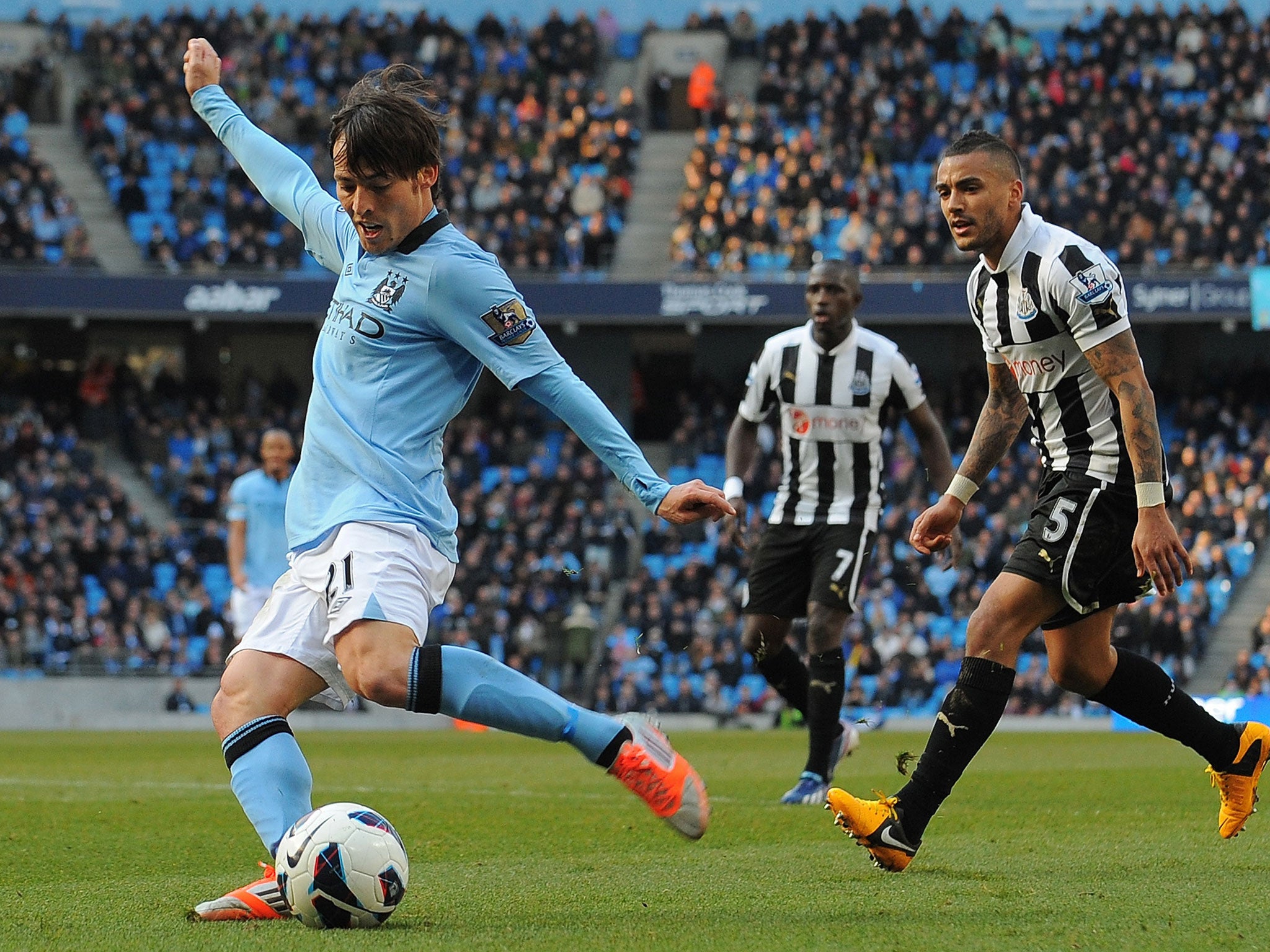 Manchester City's Spanish midfielder David Silva (L) scores the second goal