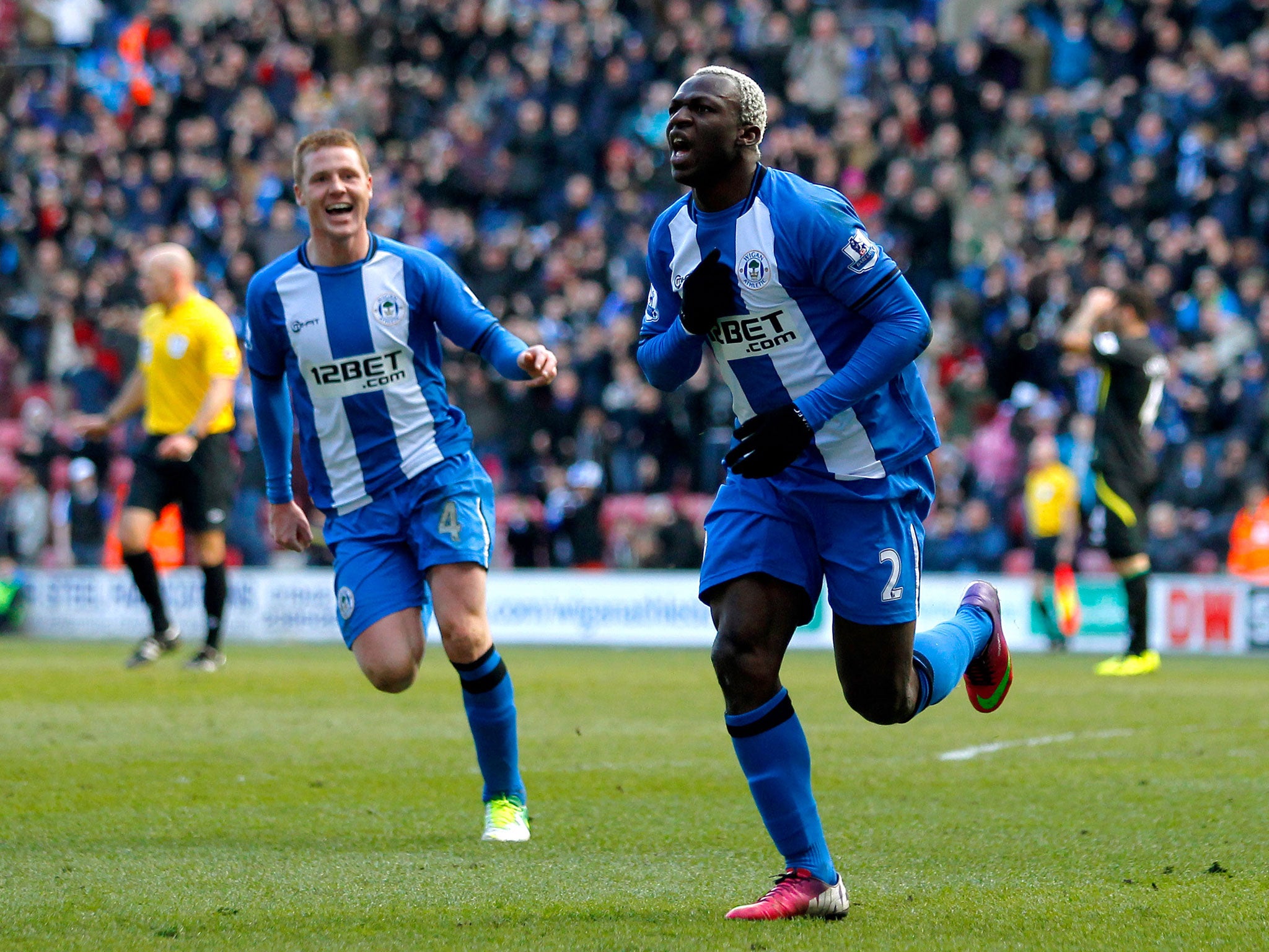 Arouna Kone (R) of Wigan celebrates his goal