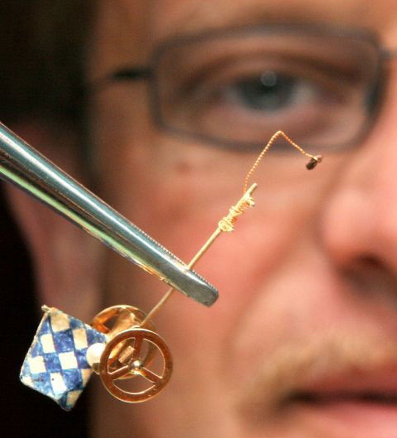 Robert Birk director of a German flea circus poses with a special cart with Bavarian flag and one of his fleas at the Octoberfest beer festival in Munich.