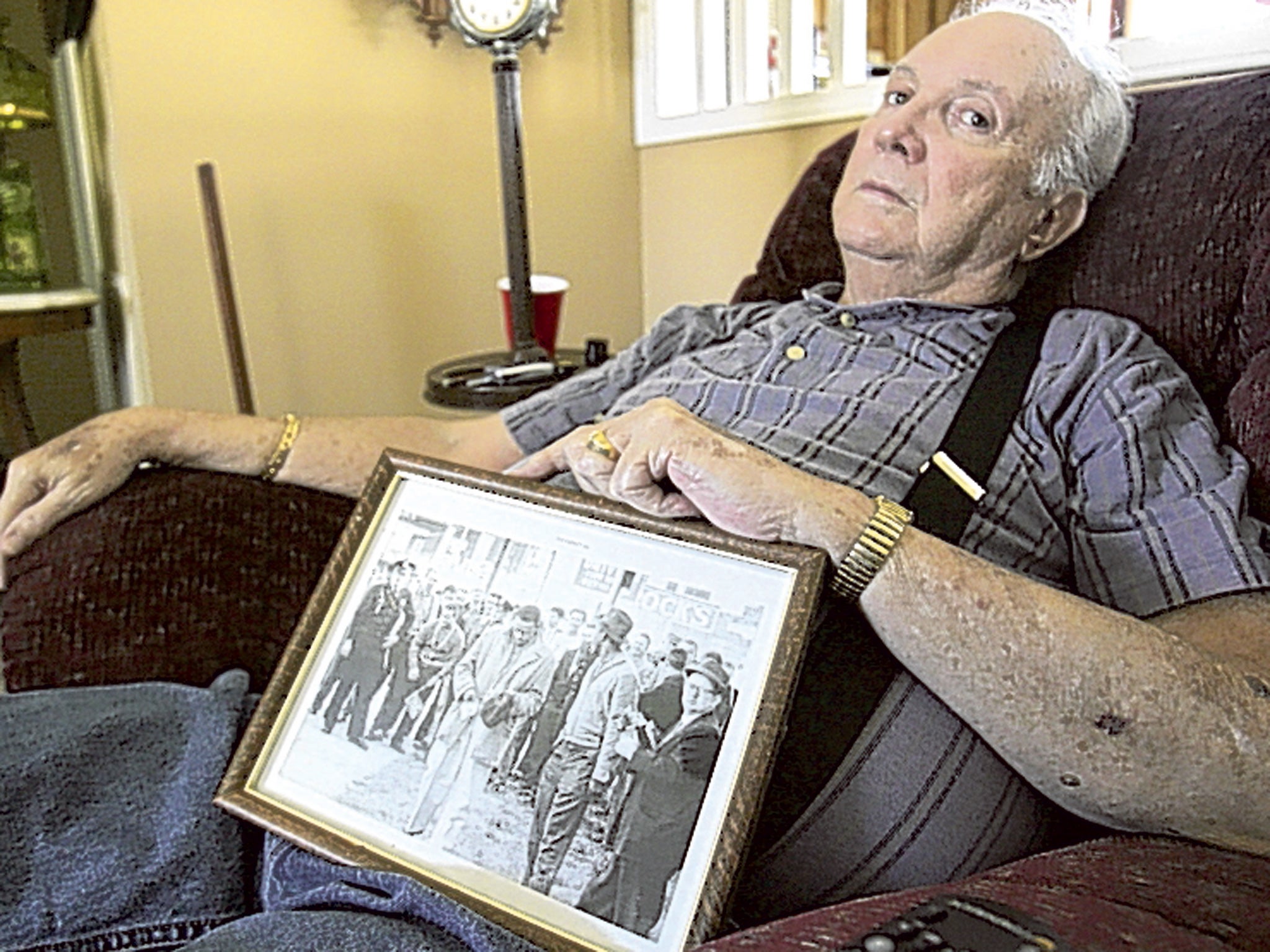 Wilson with a photograph of a mob he was part of in the early 1960s