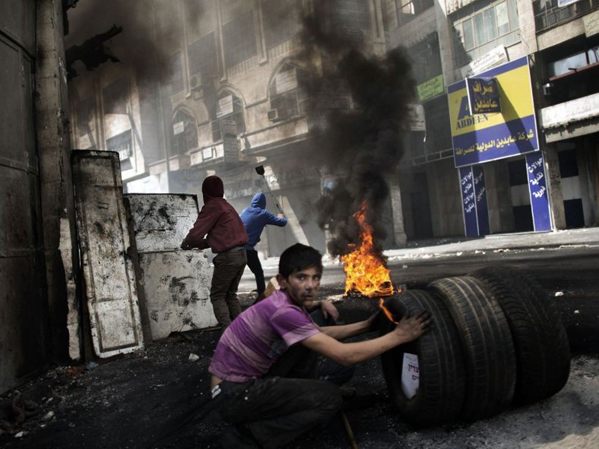 A Palestinian demonstrator looks on during clashes with the Israeli army in Hebron