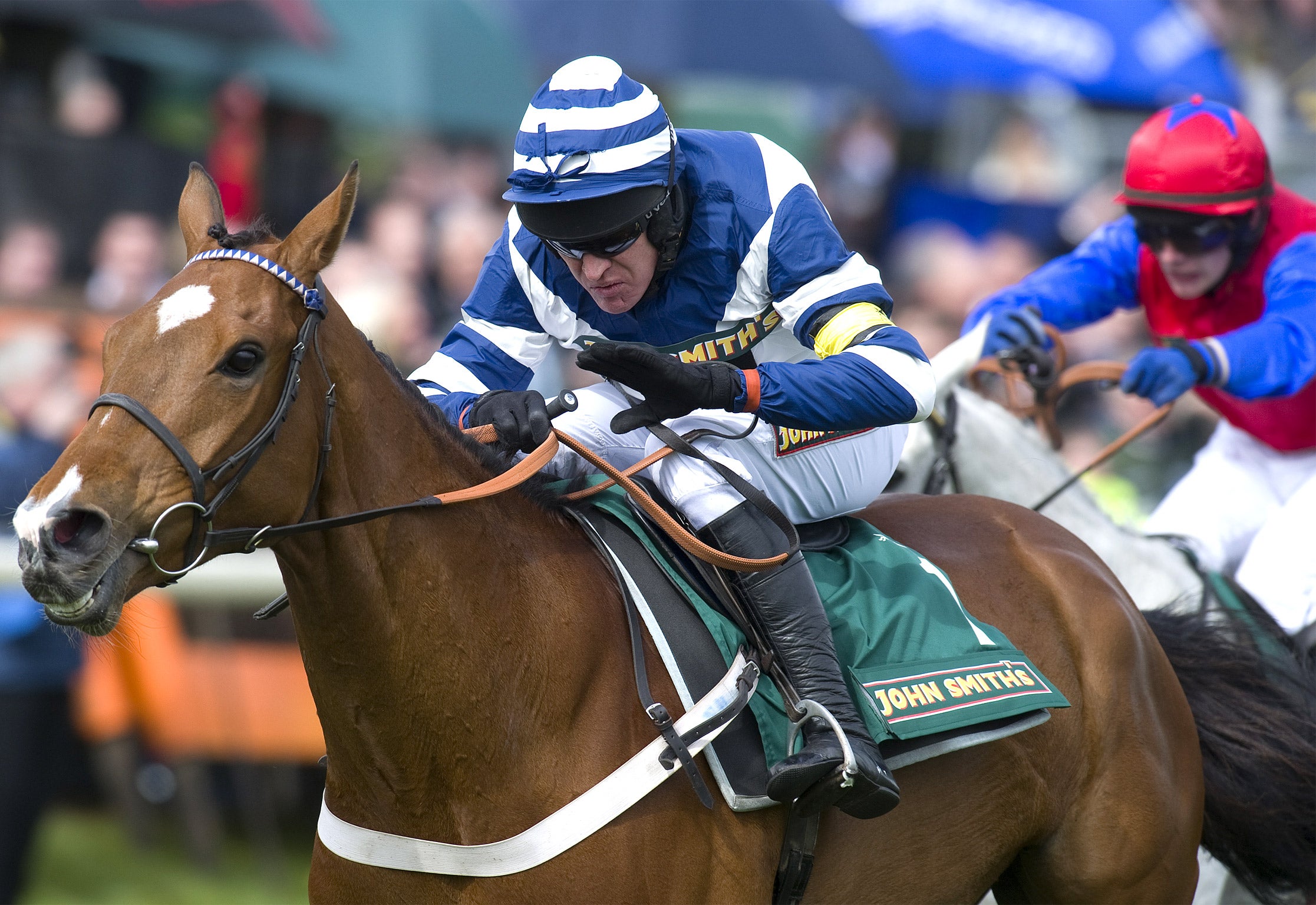 Barry Geraghty riding Oscar Whisky (left) wins the John Smith’s Aintree Hurdle from Thousand Stars (right) at Aintree last year