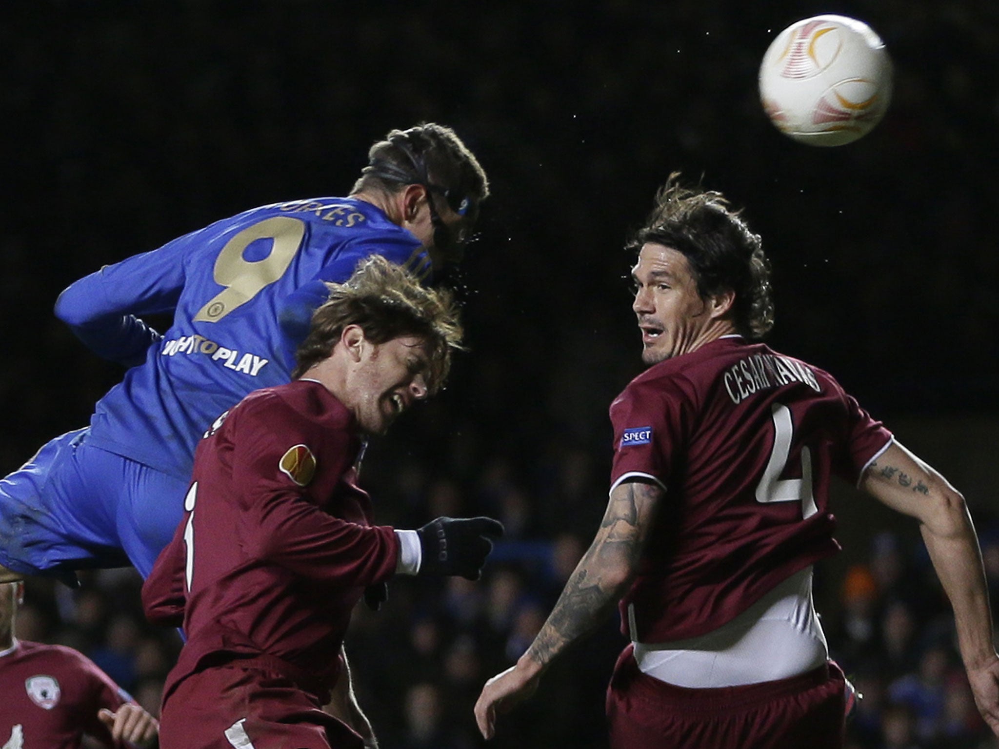 Fernando Torres rises above Rubin Kazan's Cristian Ansaldi to score his second goal