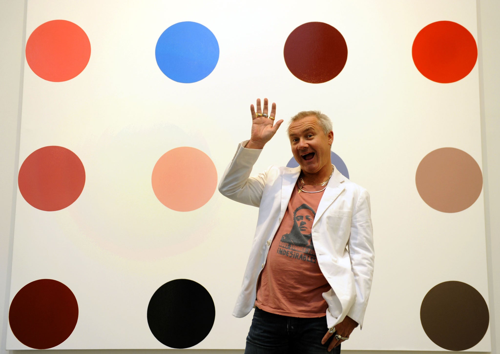 Damien Hirst with one of his spot paintings in 2012