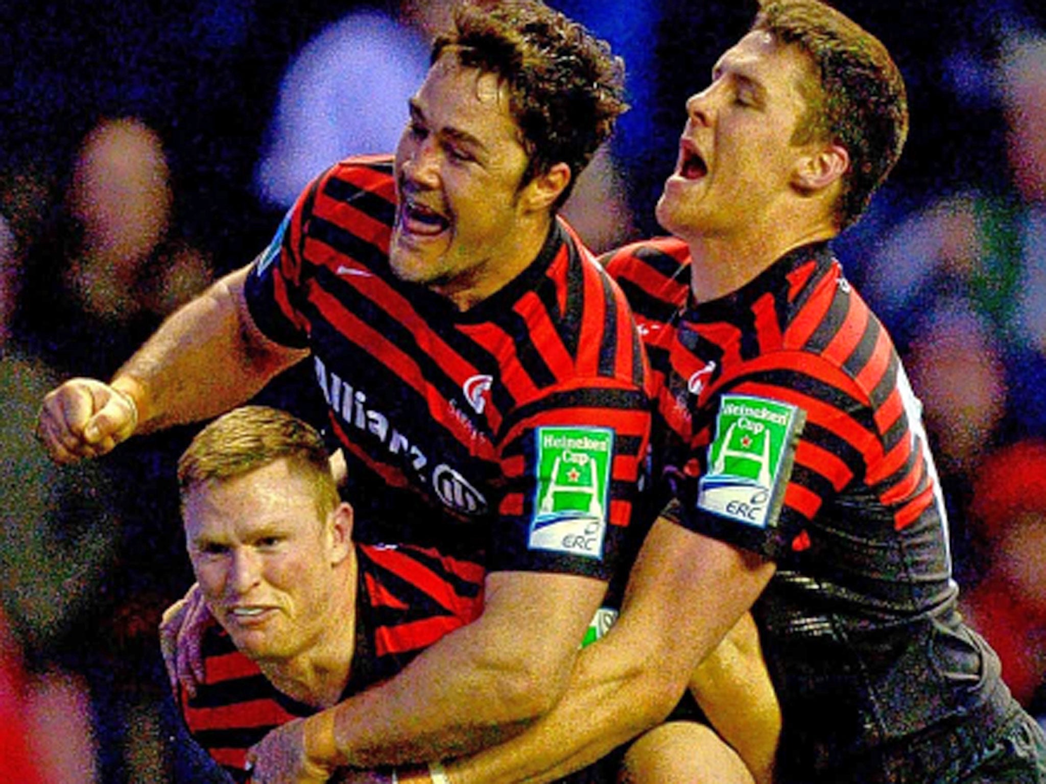 Brad Barritt and Joel Tomkins leap on Chris Ashton to celebrate his try for Saracens