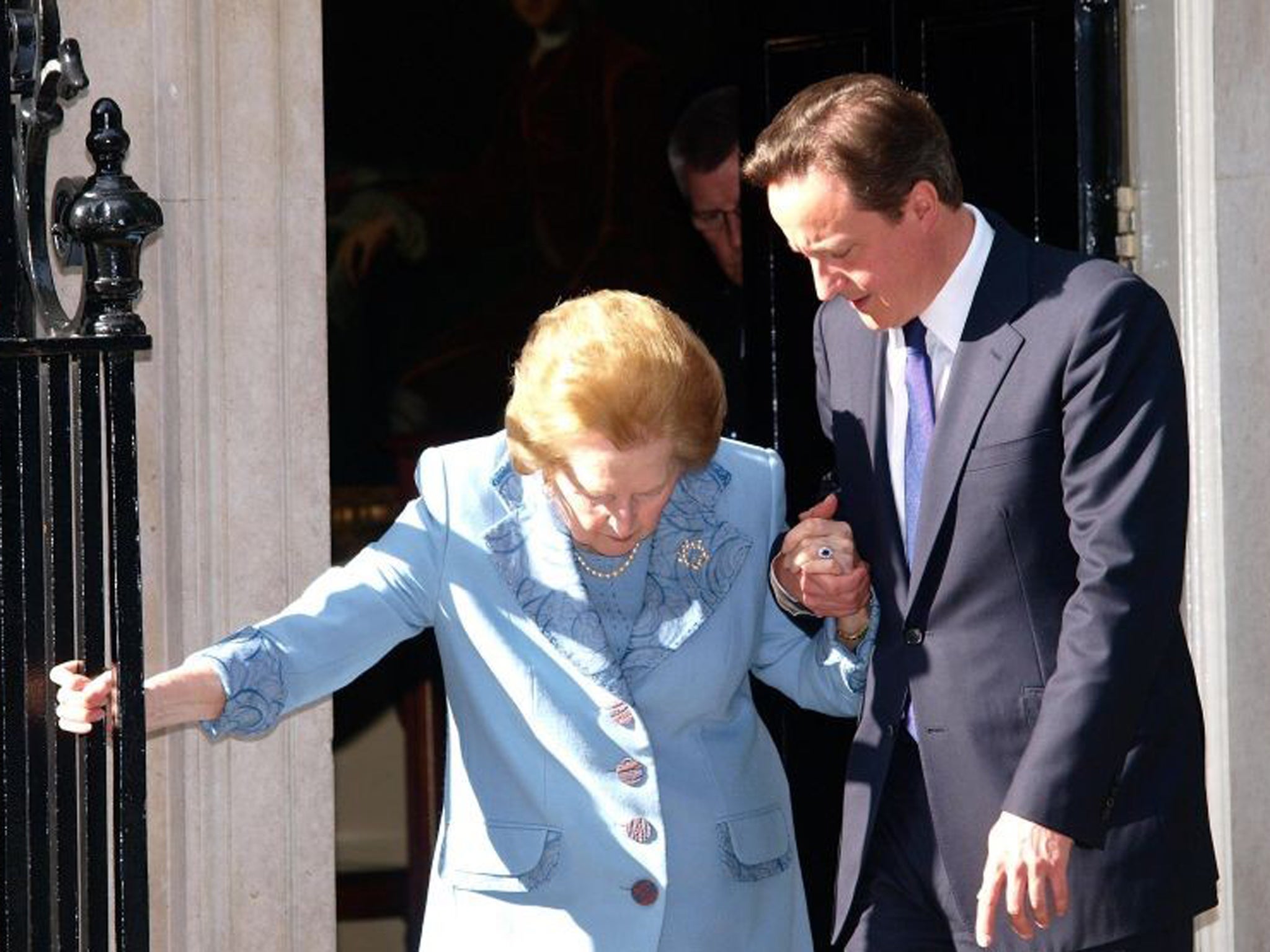 Prime Minister David Cameron helping Baroness Thatcher outside Downing Street