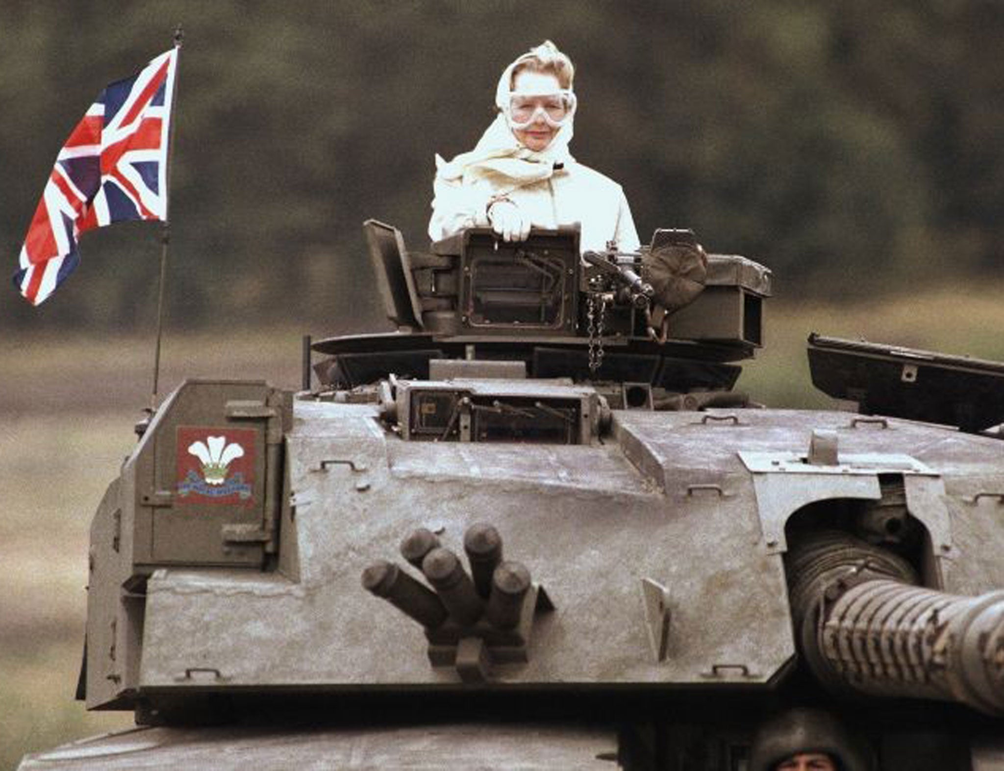 Margaret Thatcher stands in a British tank