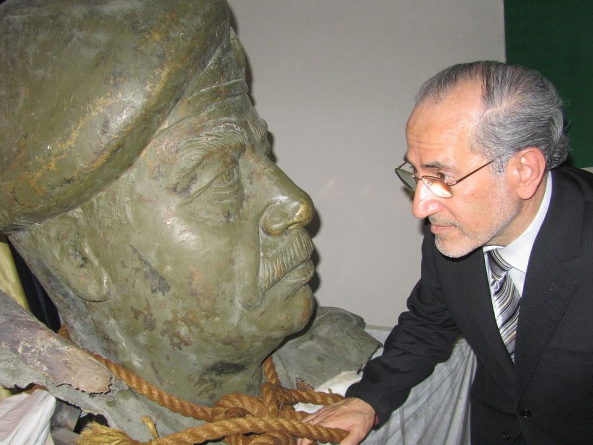 Dr Mowaffak al-Rubaie with a bust of the deposed dictator from one of his palaces and the rope used to hang him