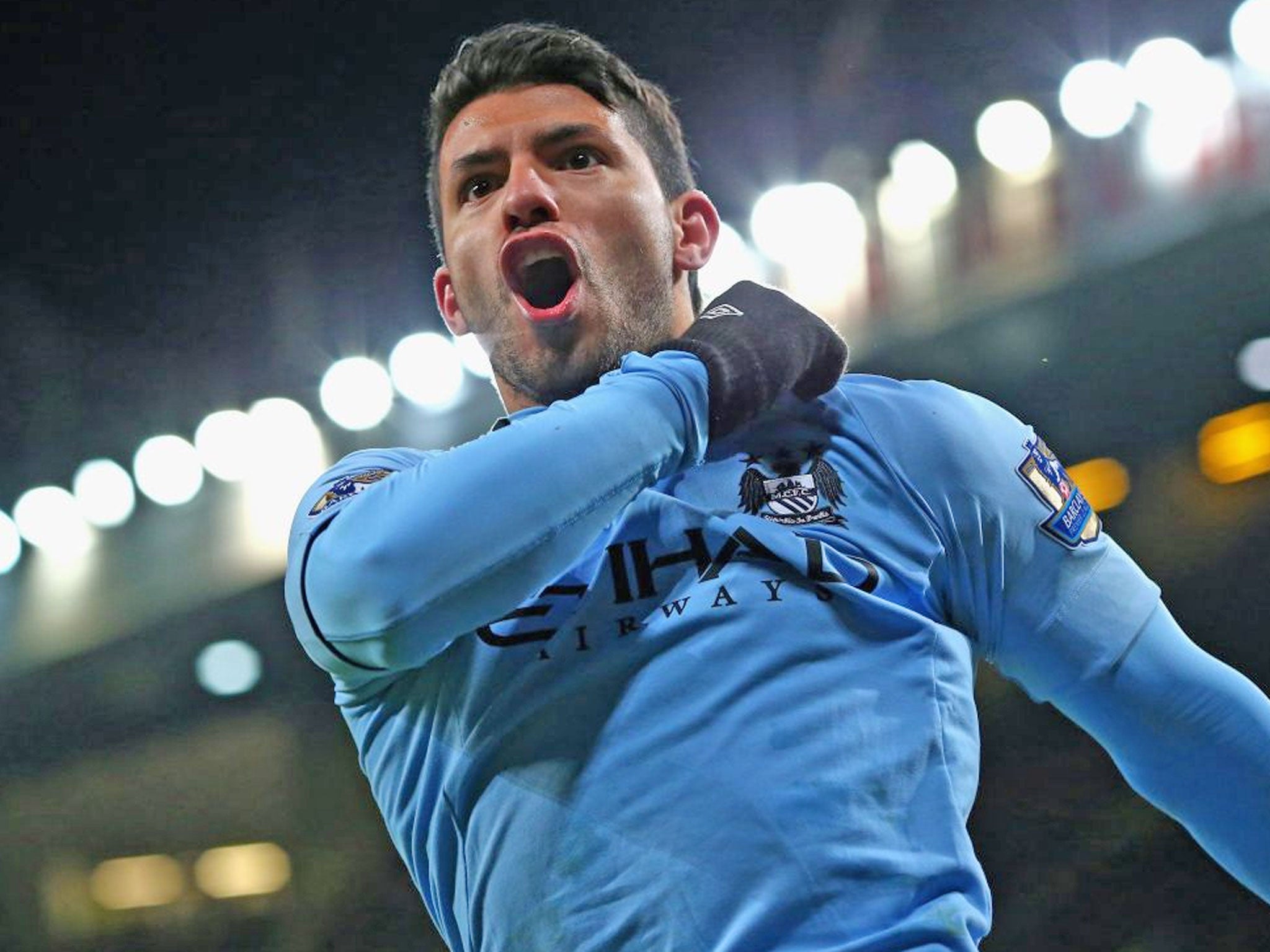 Sergio Aguero of Manchester City celebrates scoring his team's second goal against United