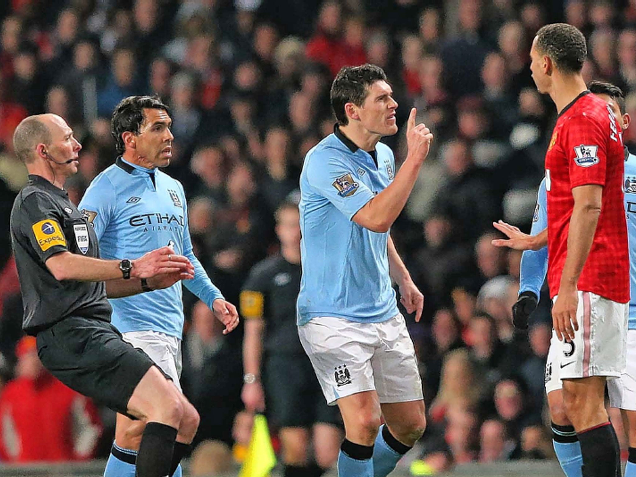 Gareth Barry and Rio Ferdinand square up to each other as tensions rise