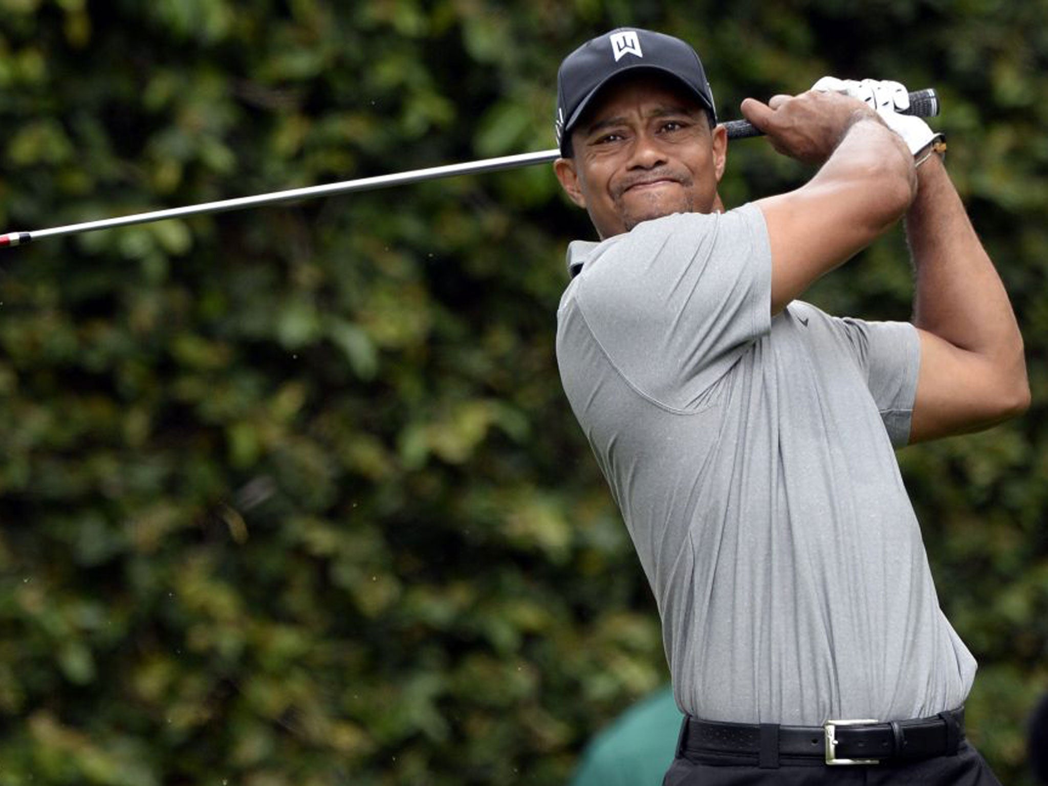 Tiger Woods drives off the tee on the second