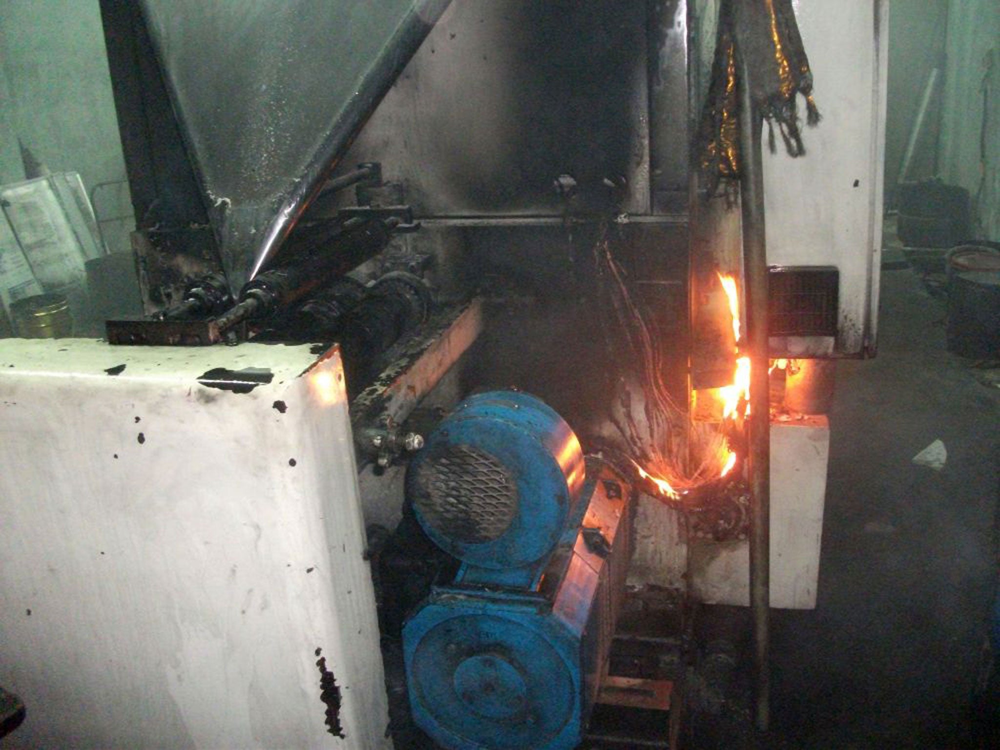 Fires burn on a printer at the Uthayan printing press in Jaffna