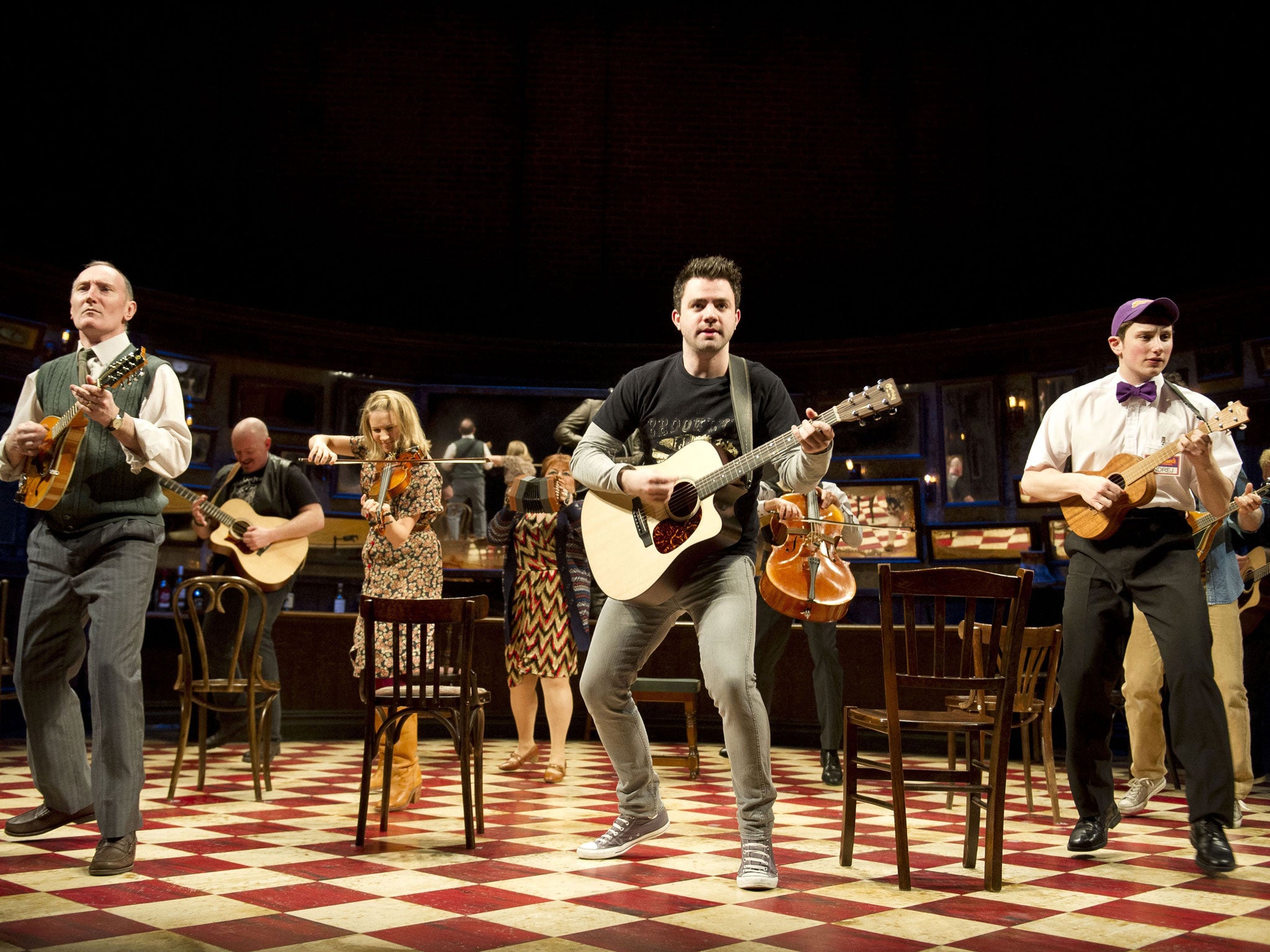 One more time ... The multitasking, rollicking cast of Once in the on-stage bar