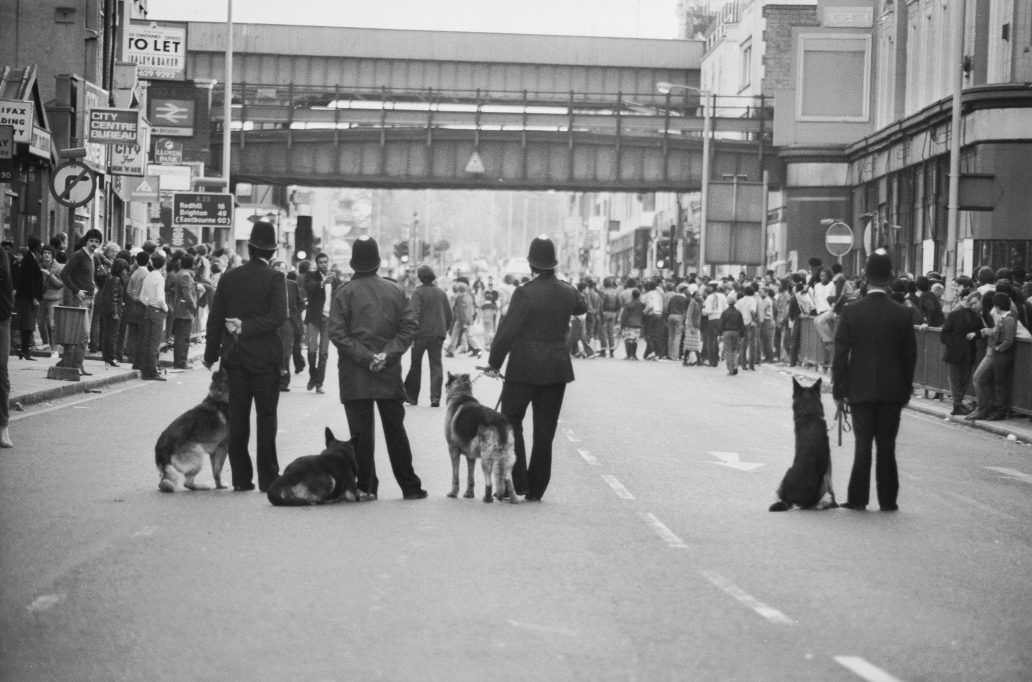 Police dog handlers on Atlantic Road on the second day of riots in Brixton, South London, 13th April 1981