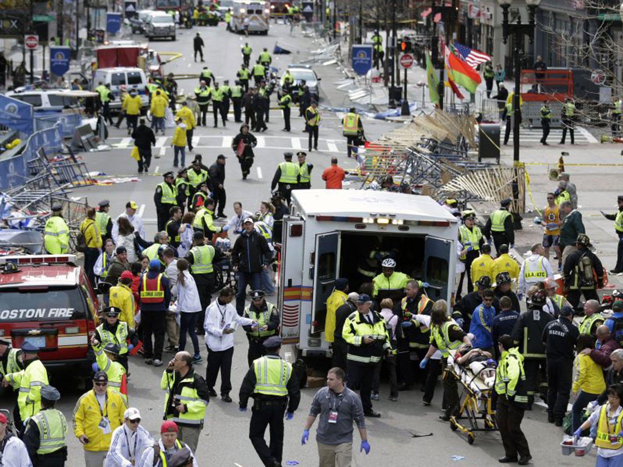 Medical workers aid injured people at the finish line of the 2013 Boston Marathon following an explosion in Boston, Monday, April 15, 2013.