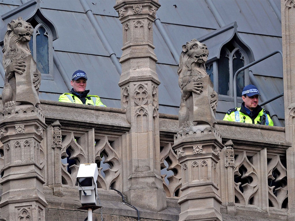 Police officers on the look out as Thatcher's body arrives at the Crypt Chapel of St Mary Undercoft in the Houses of Parliament