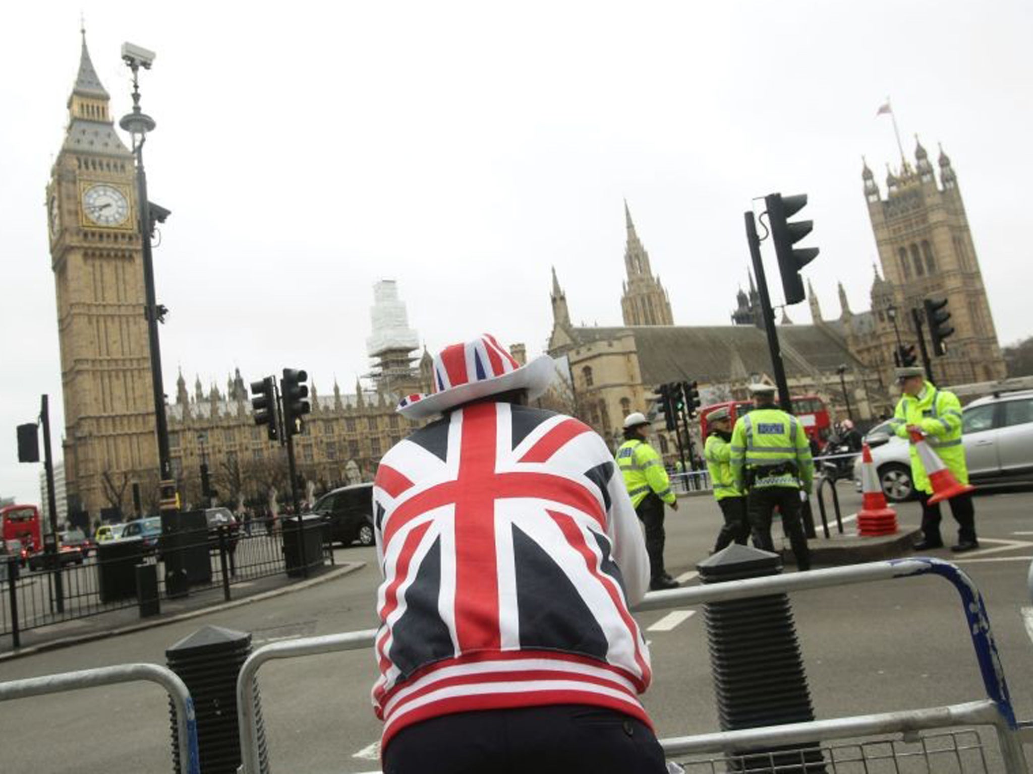 A Thatcher supporter looks across at the Houses of Parliament this morning ahead of her funeral