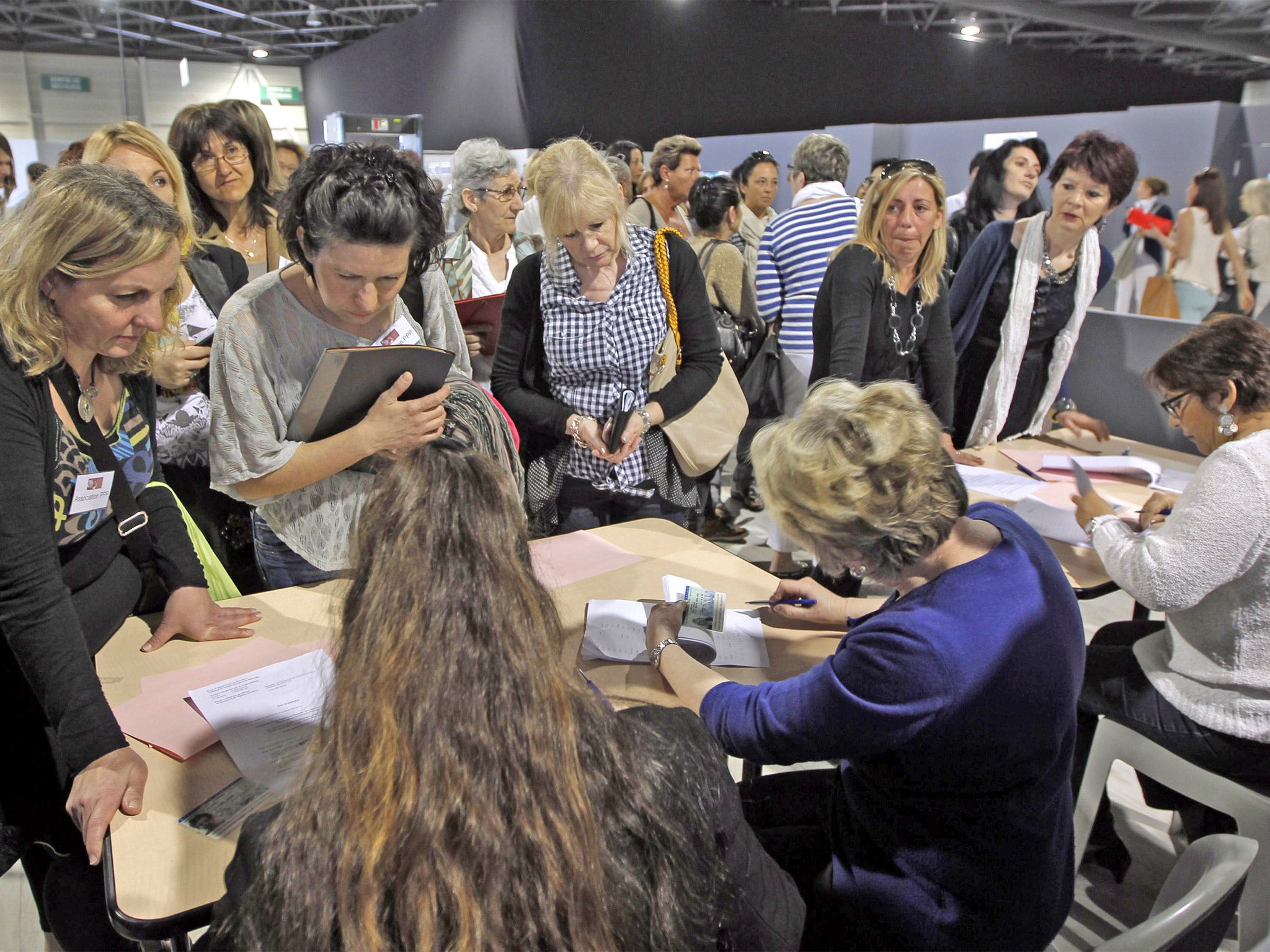 Plaintiffs arrive for the start of the trial at an improvised courthouse