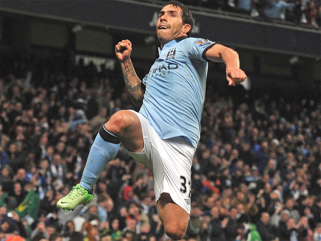 City striker Carlos Tevez celebrates his second half goal